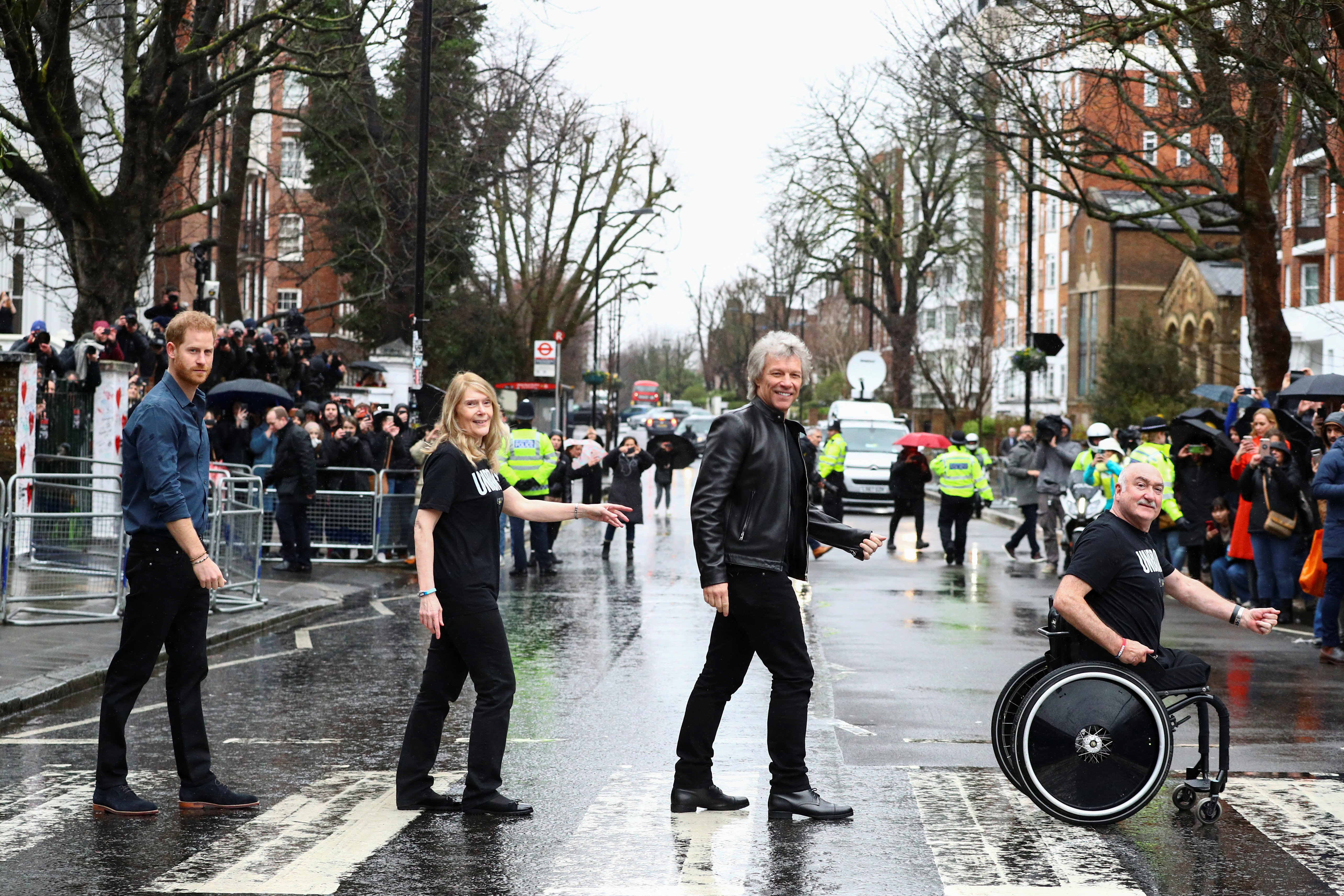 Prince Harry, Jon Bon Jovi and two members of the Invictus Games Choir recreate The Beatles' Abbey Road album cover (Picture: PA)
