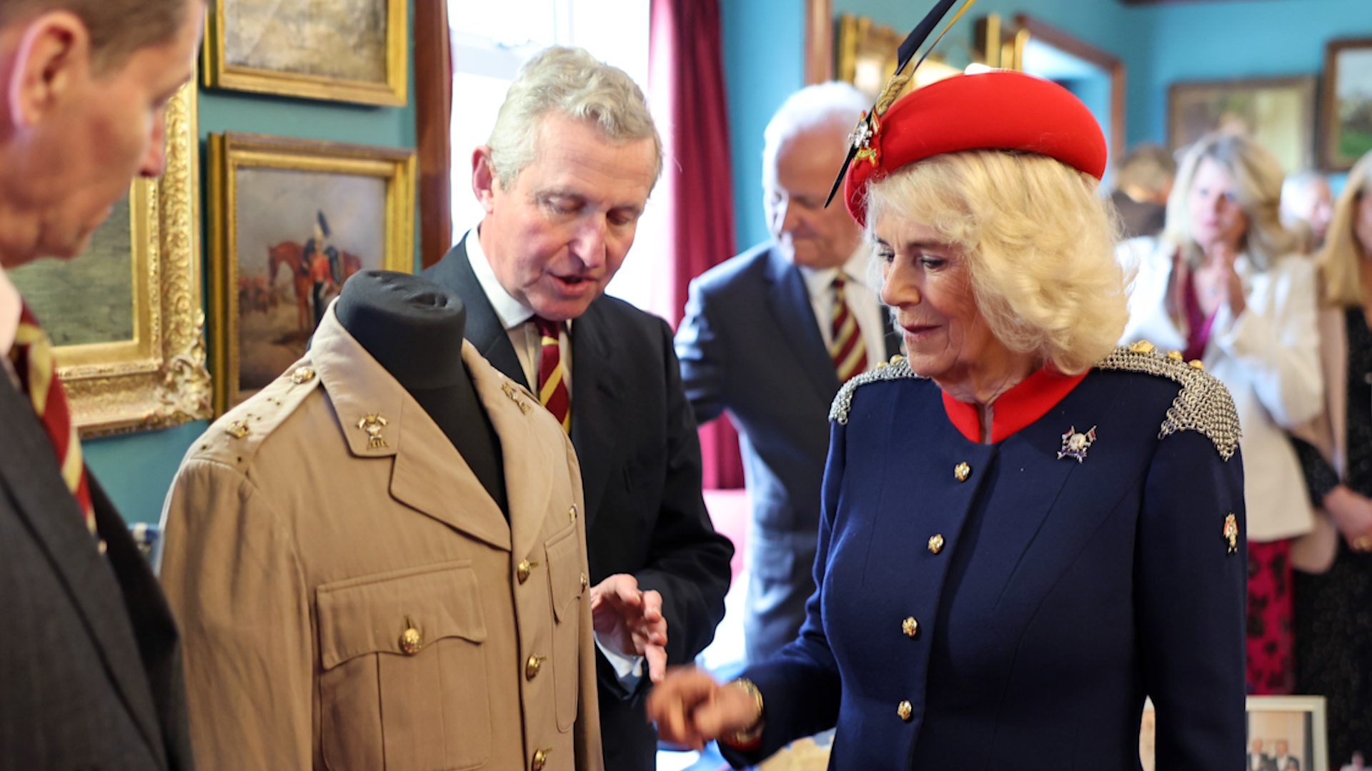 Queen Camilla views the tunic belonging to her late father Major Bruce Shand