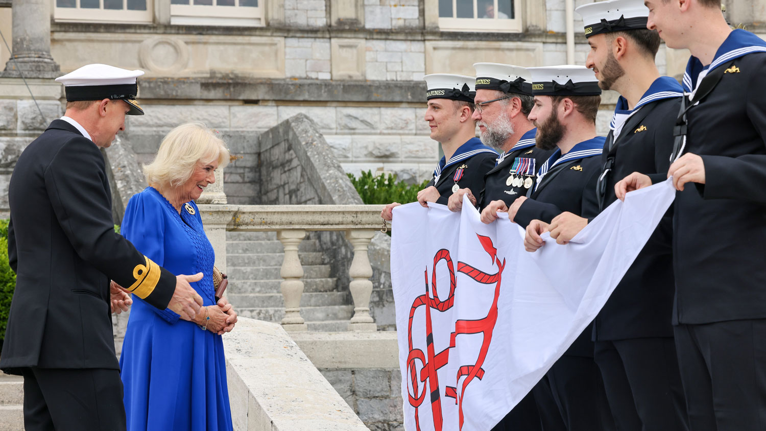 Queen Camilla is formally presented with a burgee pennant by Rear Admiral Andy Perks, Head of the Submarine Service CREDT Royal Navy