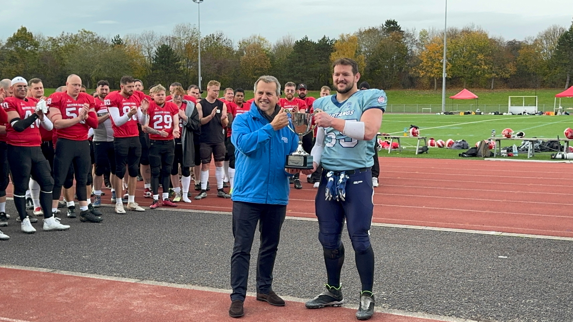 RAF Captain Corporal Curtis Colhoun lifts the IS American Football trophy presented by Chair UKAF Sports Board Air Commodore Rich Fogden