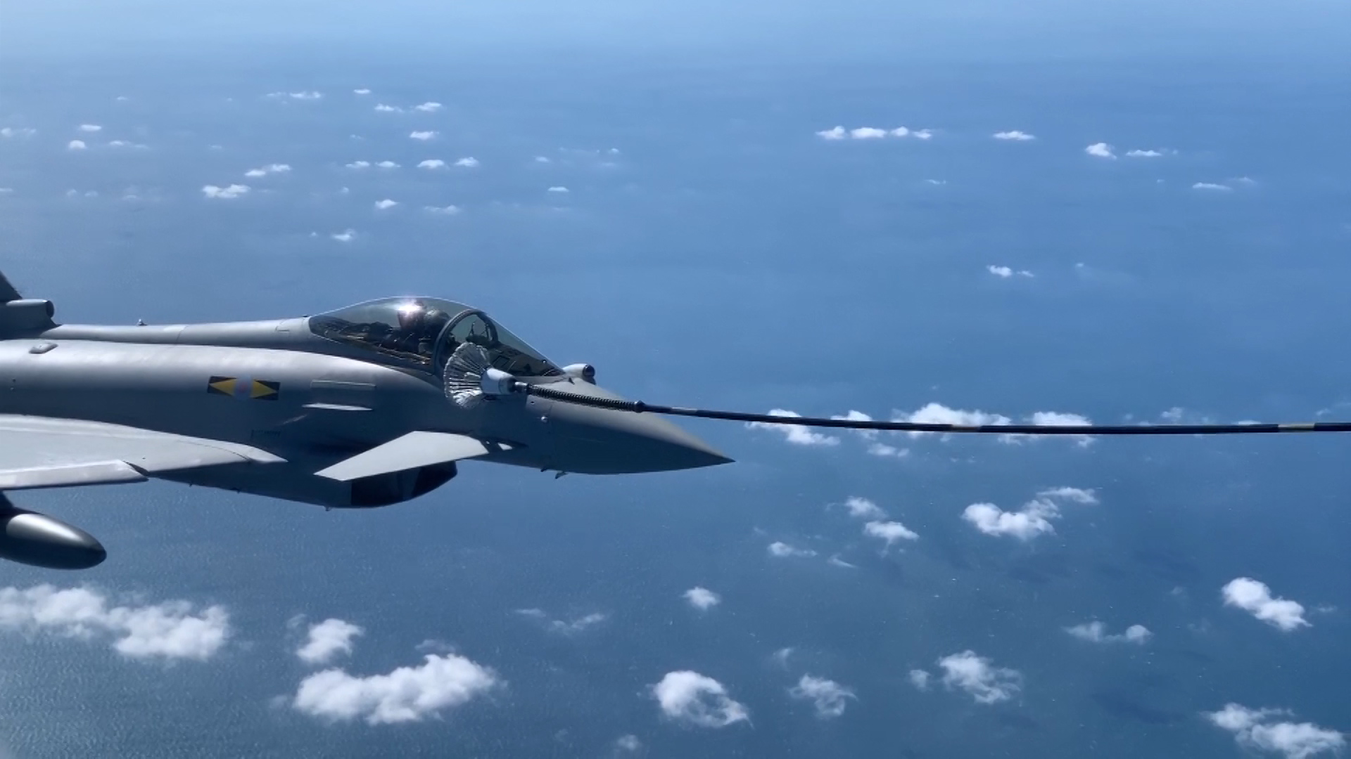 RAF Typhoon refueling with a hose from an RAF Voyager plane.