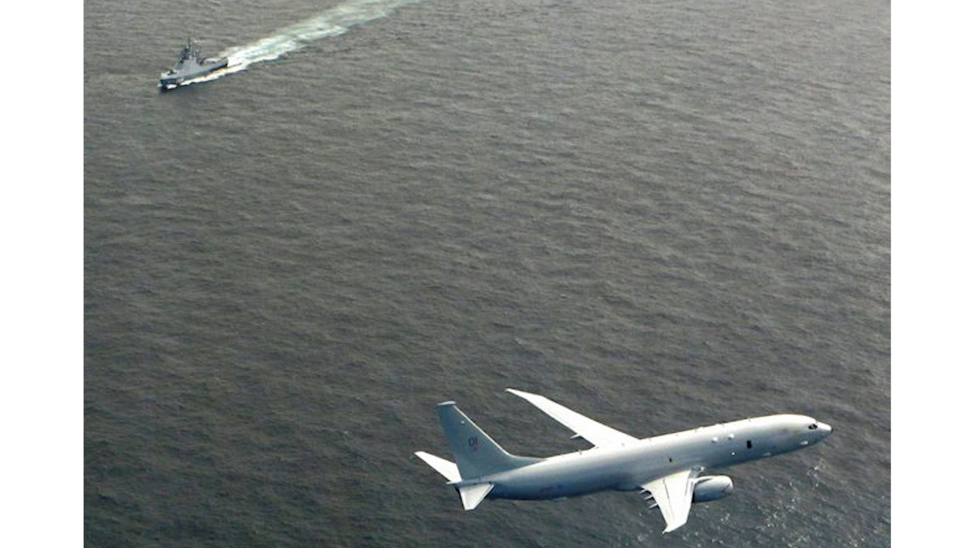 RAF P-8A Poseidon flys over Vasily Bykov over the North Sea during aicraft's first operational mission