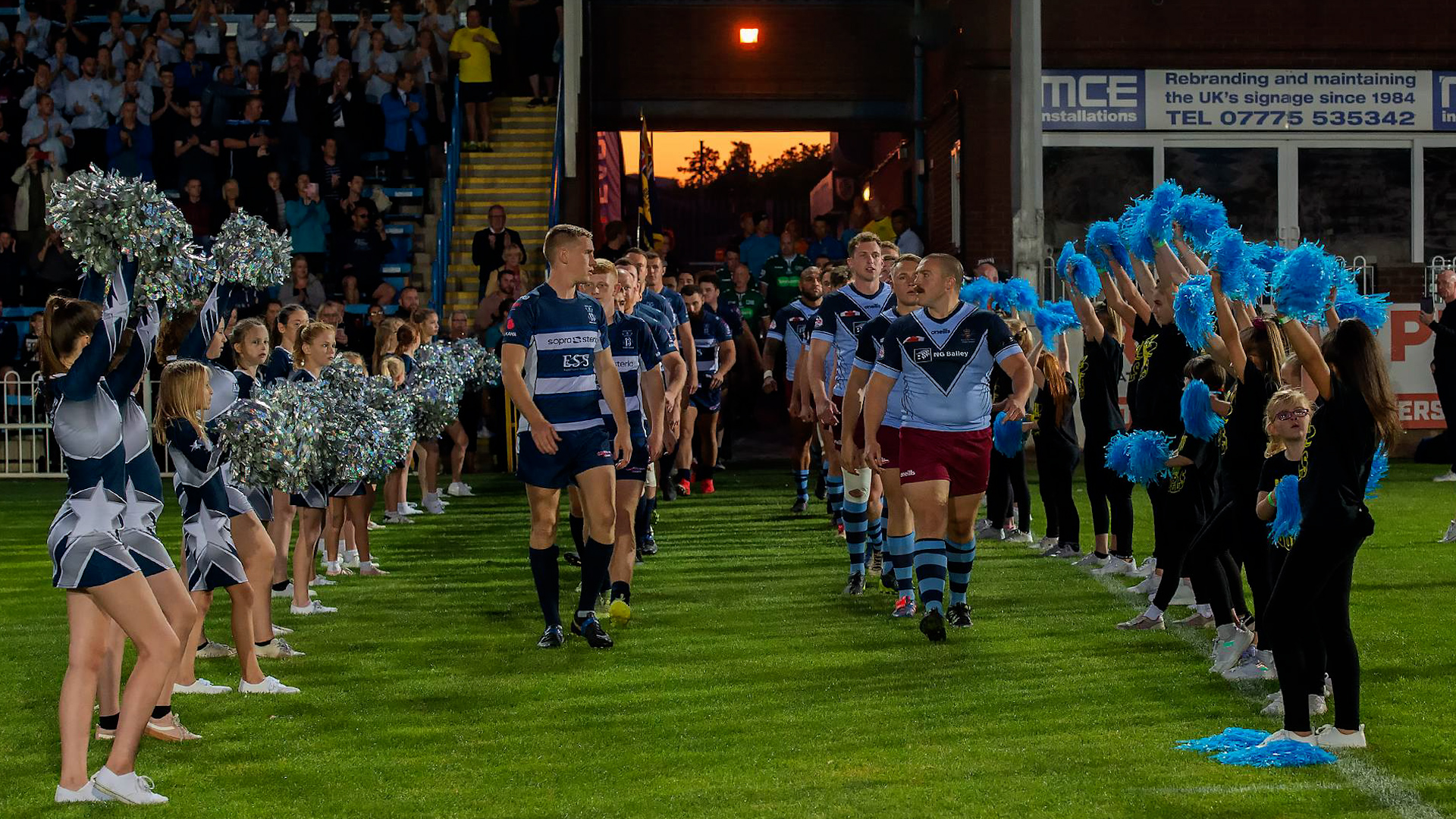 RAF and Navy rugby league players enter the field of play for an Inter Services match in 2019