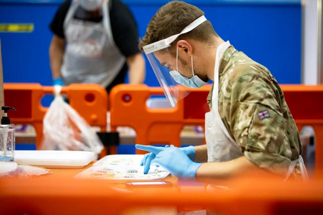Cover image: RAF service member during a coronavirus testing scheme in Merthyr Tydfil, Wales (Picture: MOD).