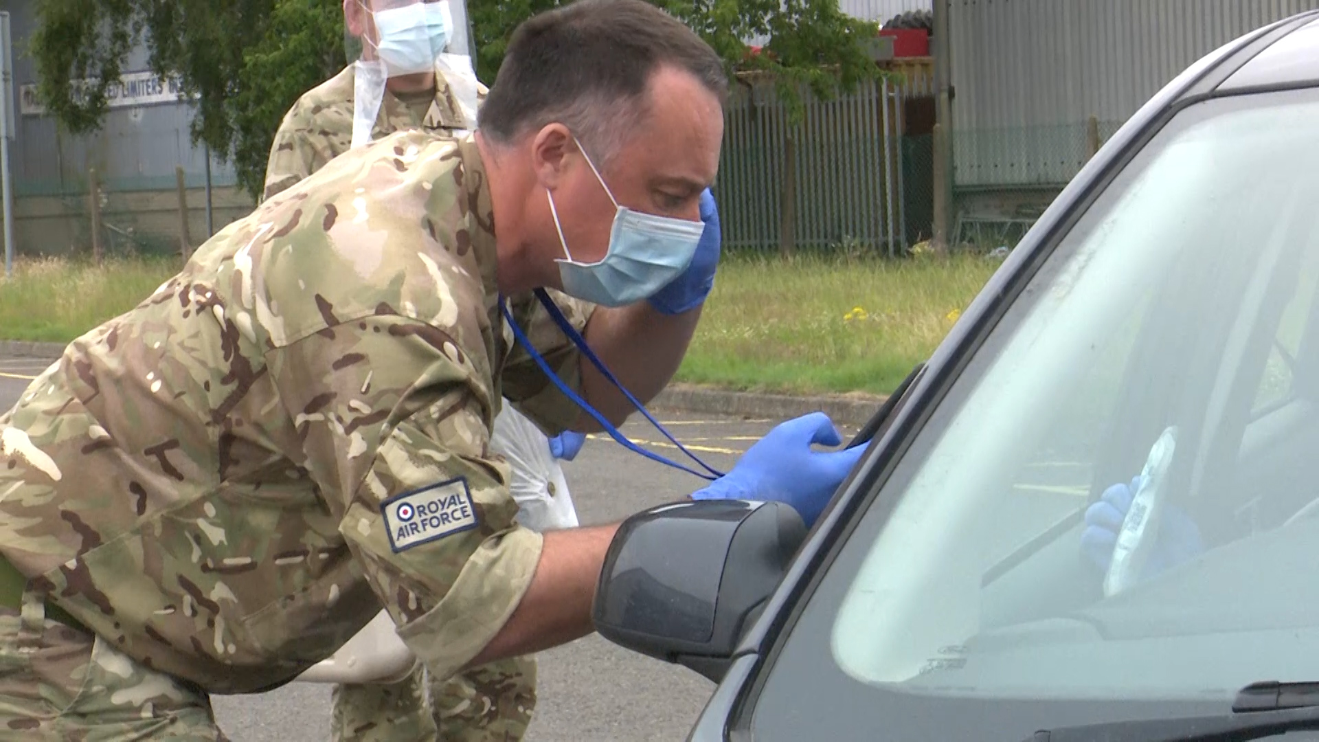 RAF reserve interacts via phone with driver at mobile testing unit in Shrewsbury 150720 credit bfbs