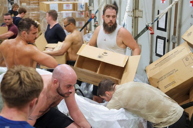 RFA Argus crew and embarked forces preparing load bags with humanitarian aid consisting of food, water and sanitary products ready to be air lifted to Honduras 201120 CREDIT MOD