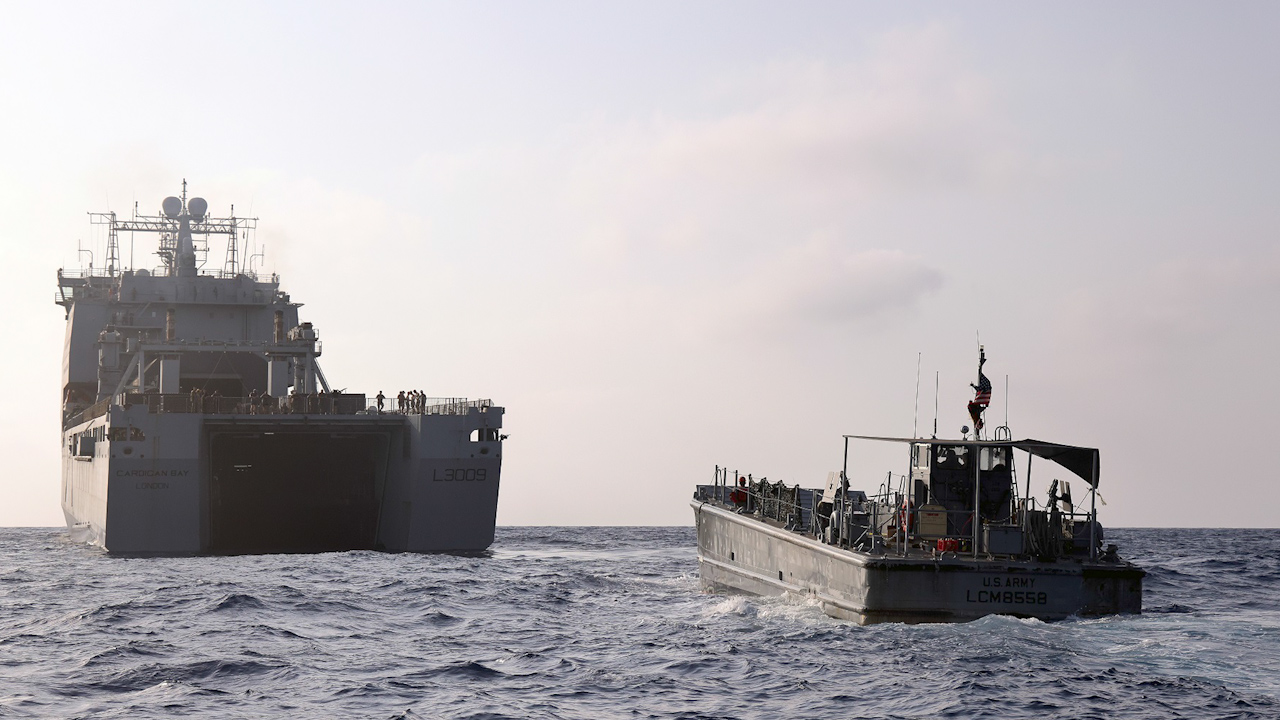 RFA cardigan bay with a us water craft sailing to the gaza pier