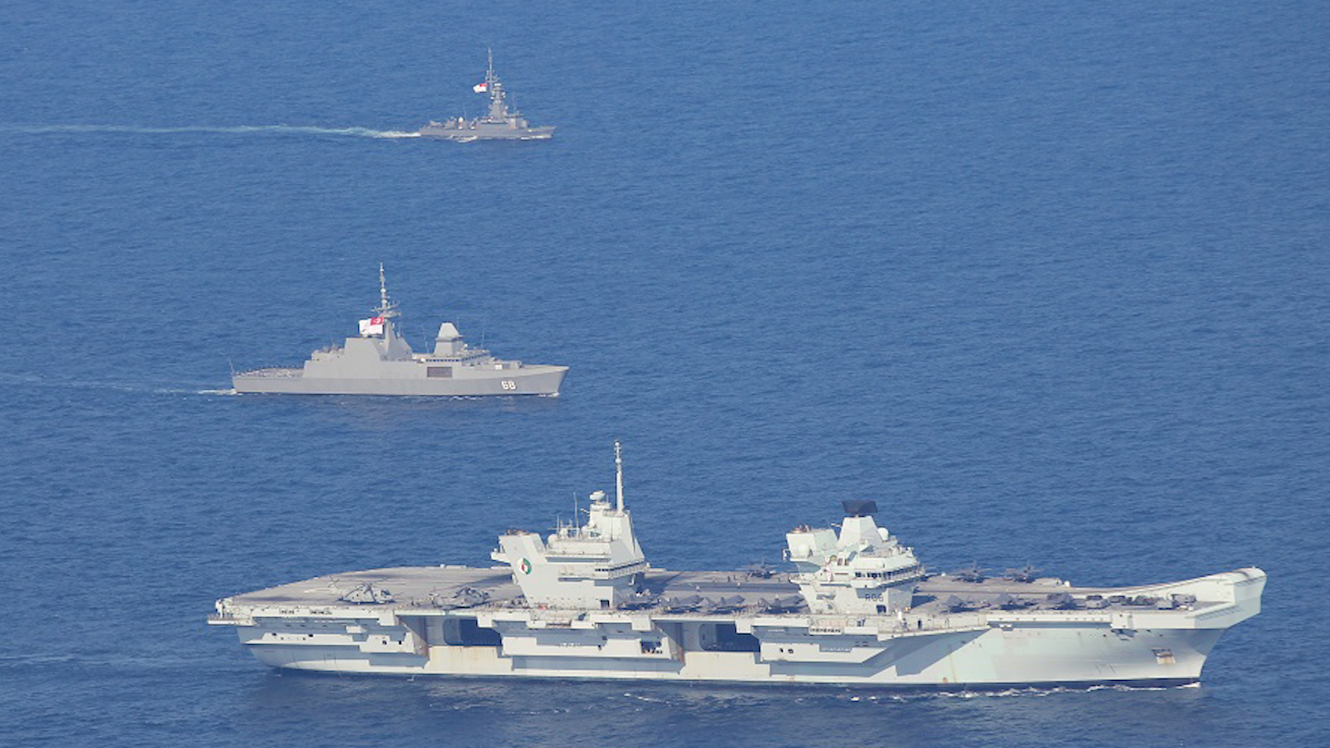 RSS Vigour and RSS Formidable from the Republic of Singapore Navy and the UK Carrier Strike Group's HMS Queen Elizabeth exercising together (Picture: Royal Navy).