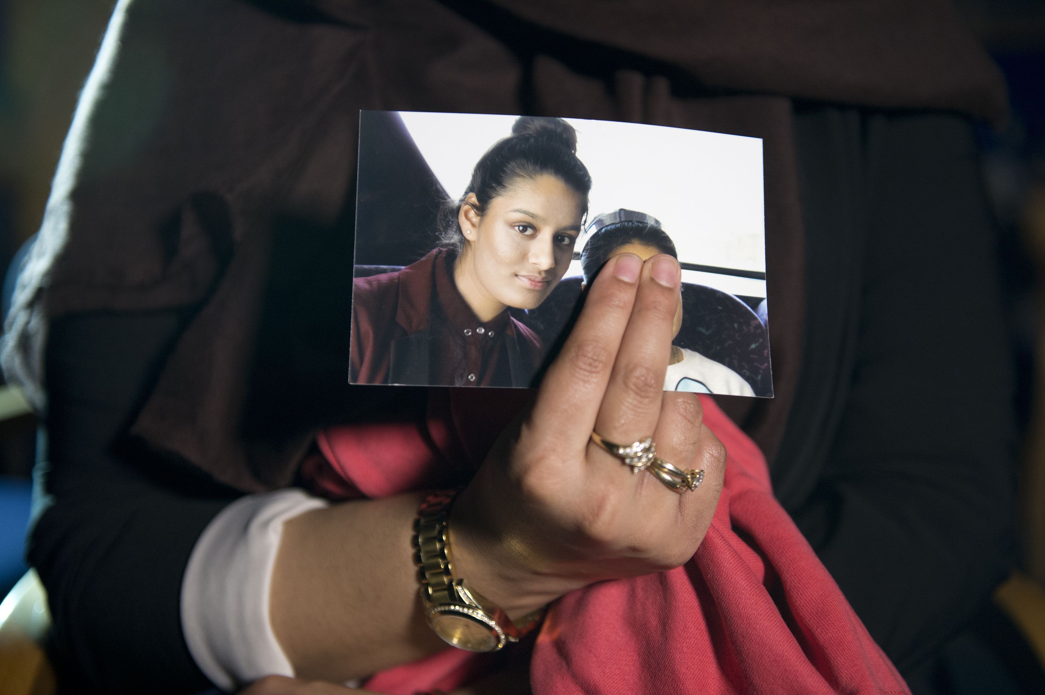 Renu - eldest sister of Shamima Begum - holds her sister's photo while being interviewed by the media at New Scotland Yard 220215 CREDIT PA