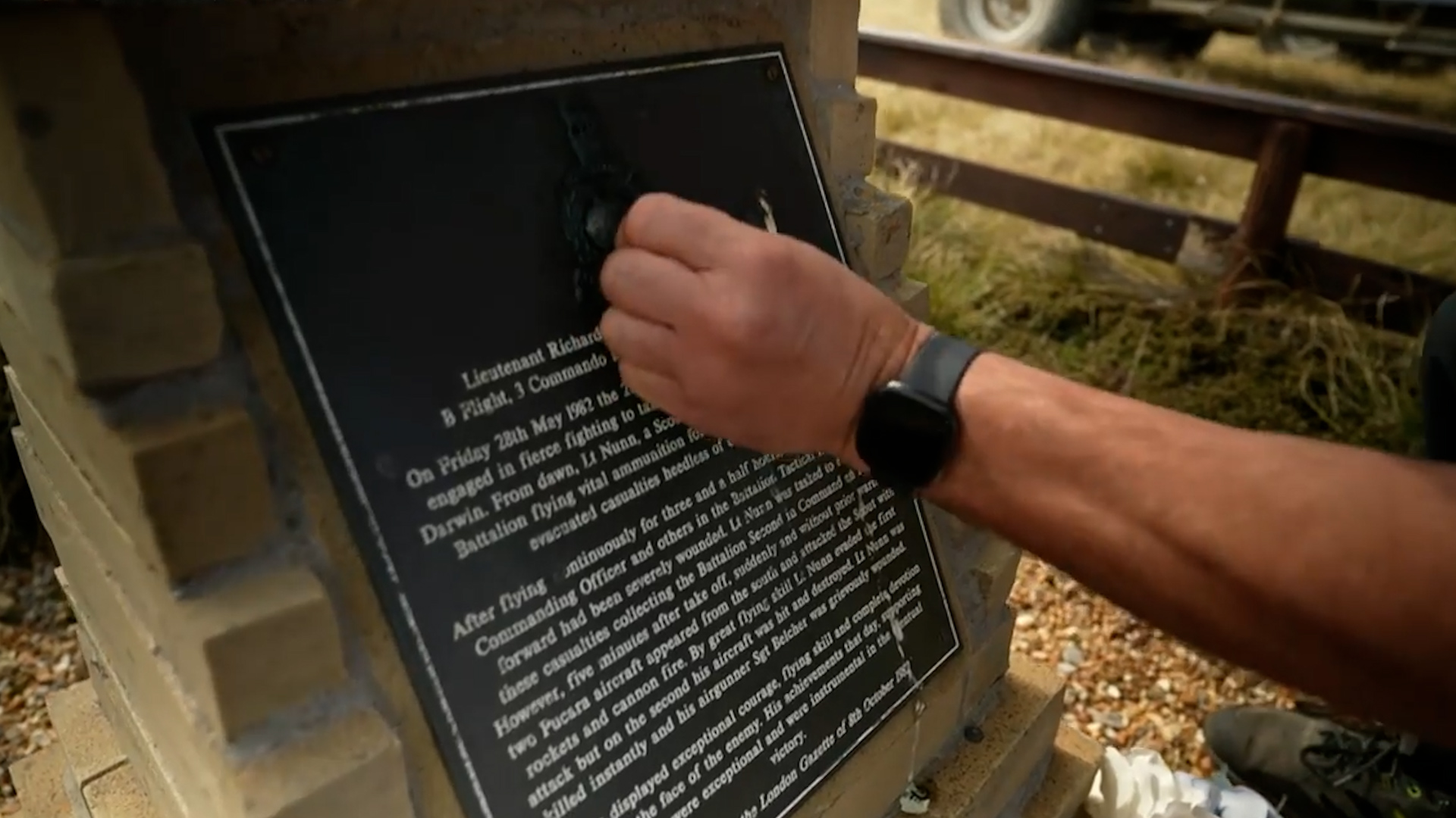 Rob Stenhouse cleans Lt Richard Nunn's plaque CREDIT BFBS