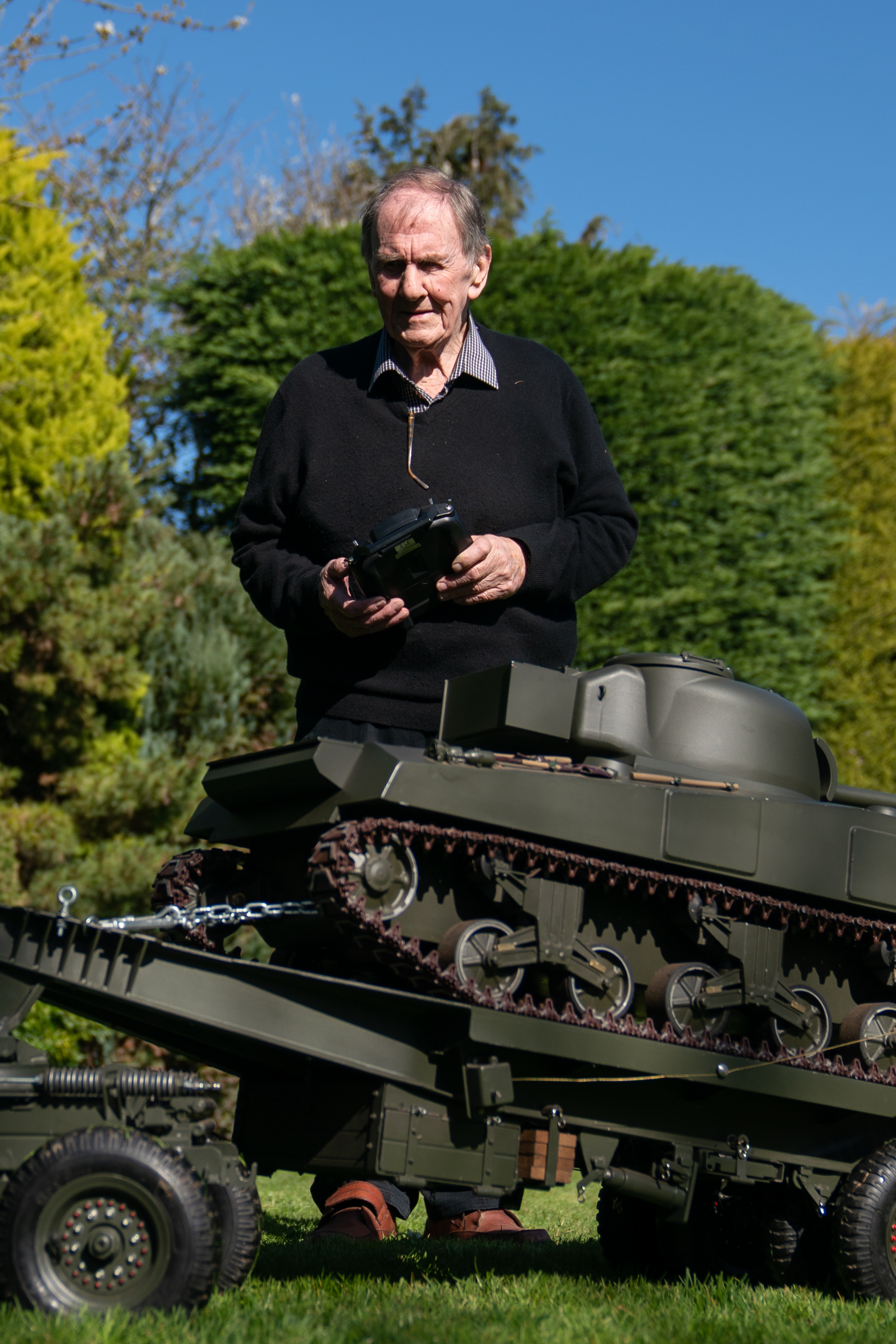 Roland Hopper in his garden near Saffron Walden, Essex, with his 8ft remote control model tank and model tank transporter lorry