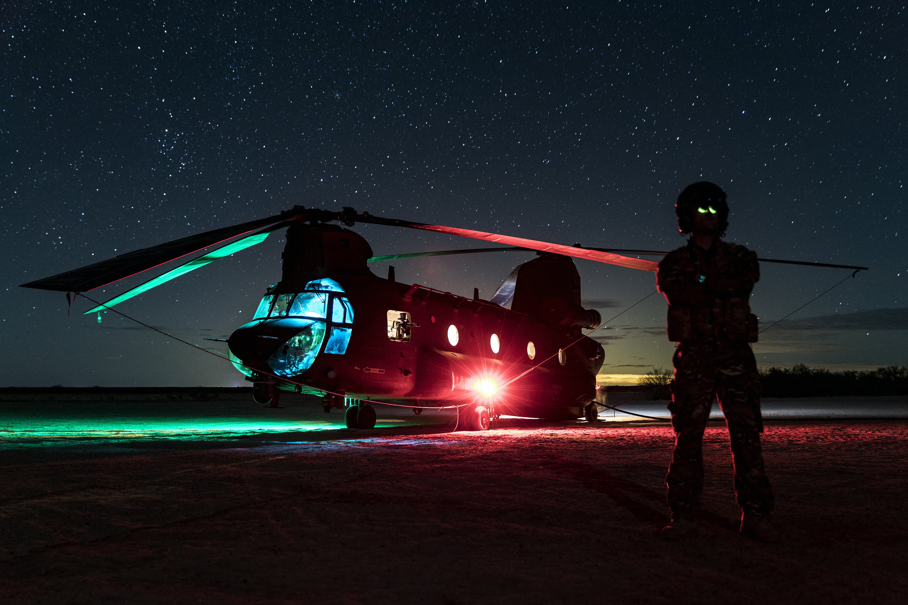 A Royal Air Force CH-47 Chinook helicopter rests at night during a training mission in the Arizona desert. The chinook was being used at a FARP to refuel USMC helicopters (Picture: RAF).