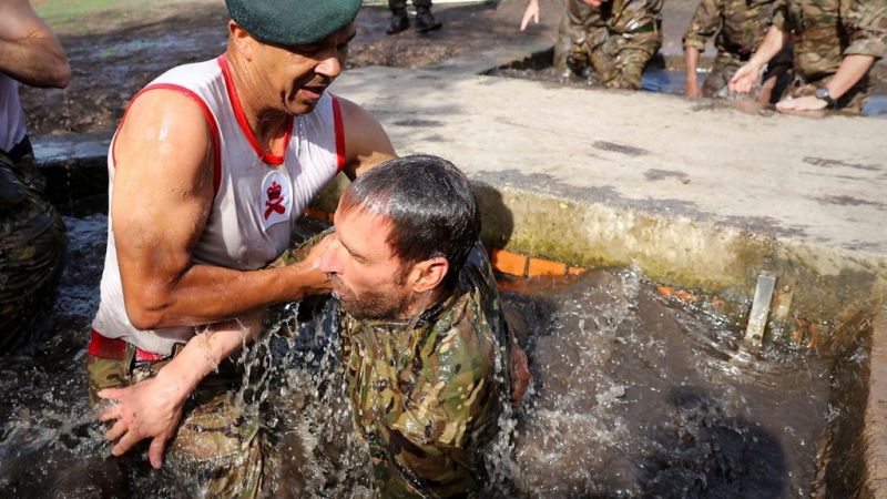 Royal Marine Scotty Mills and Gareth Southgate during 'sheep dip' 020617 CREDIT MOD