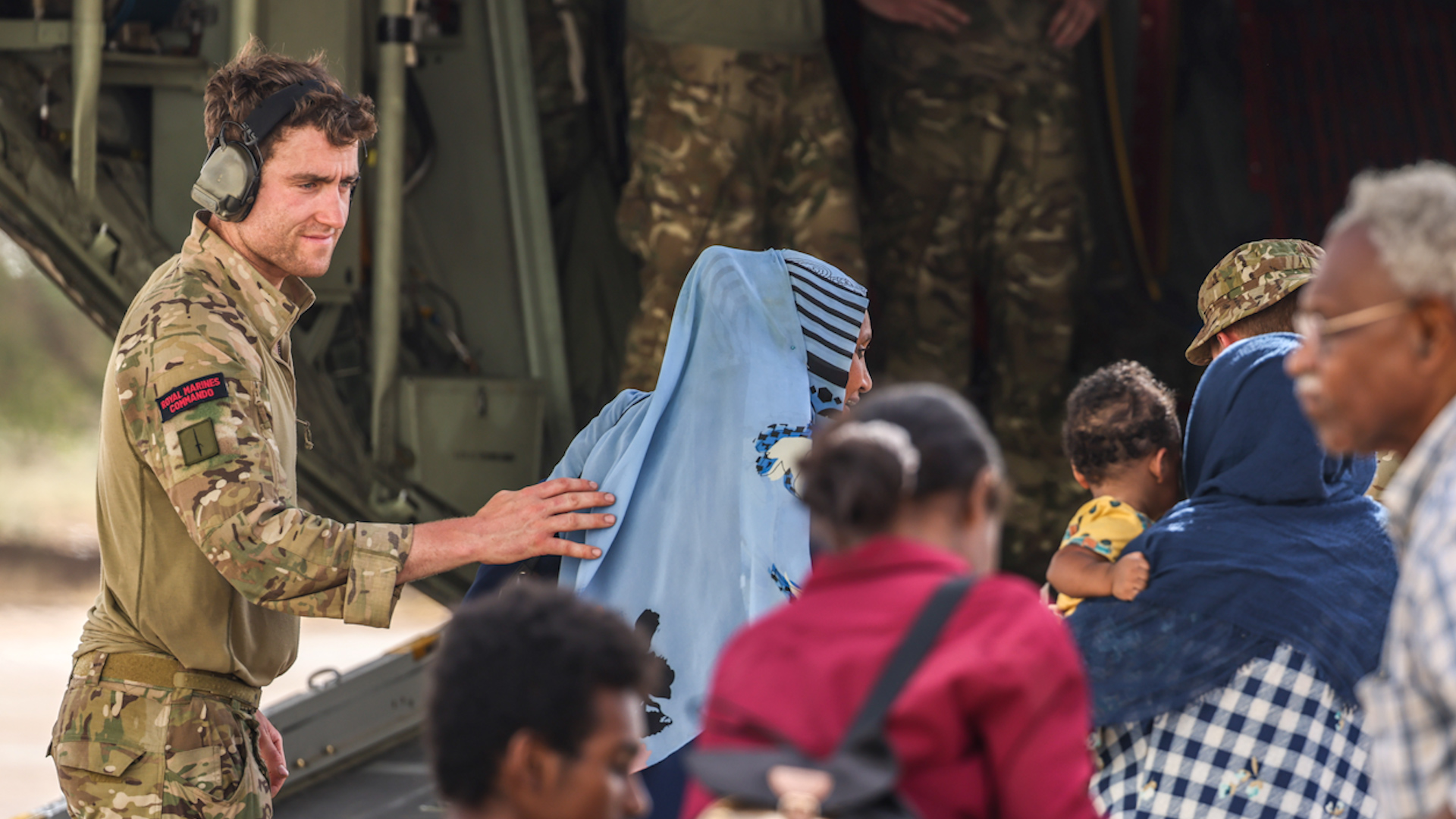 Royal Marine assists evacuees on to the RAF C-130 at Wadi Seidna airport in Sudan 27042023 CREDIT MOD Crown Copyright