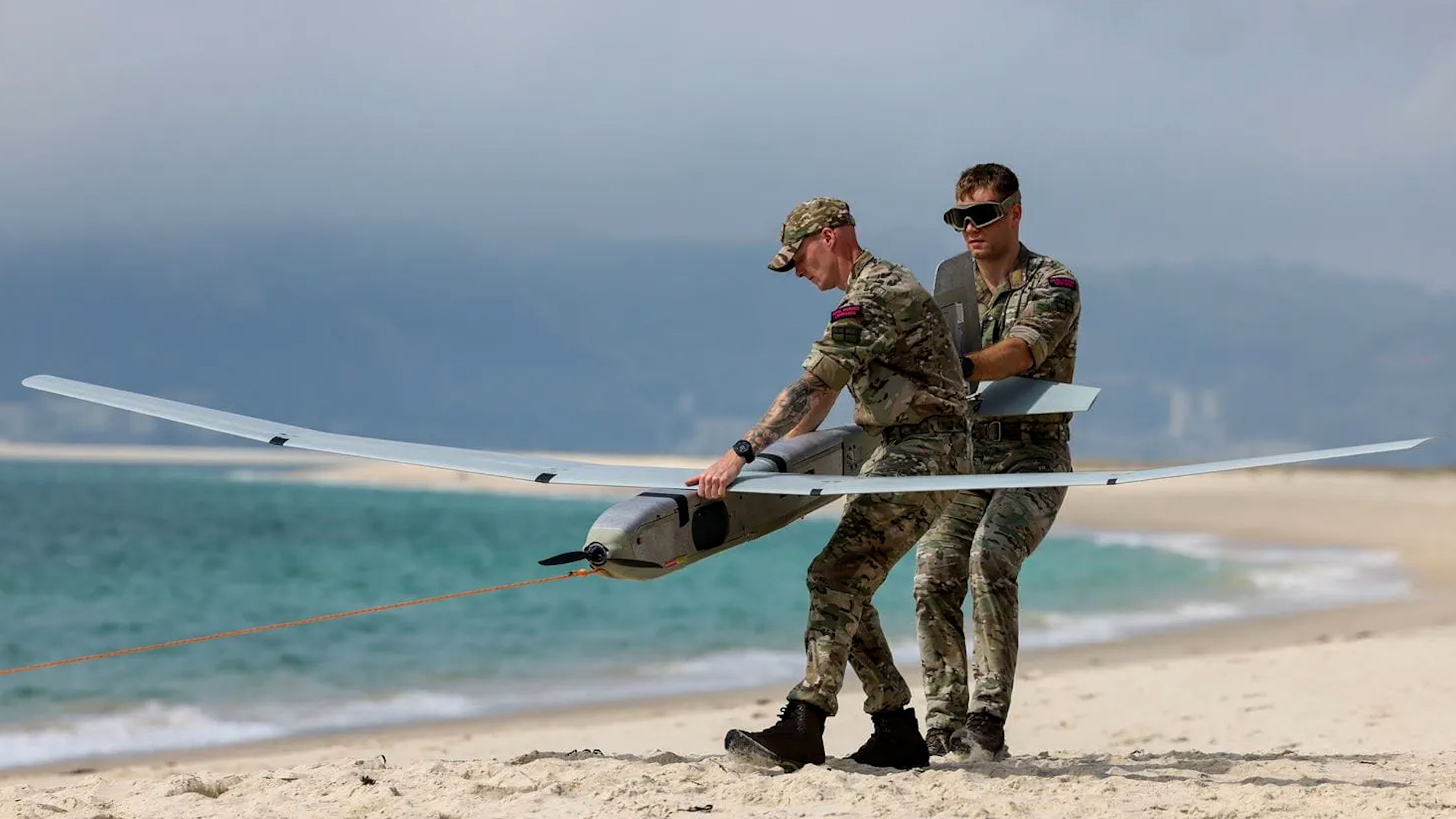 Members of the Royal Marines Commandos from 700X Naval Air Squadron launching a Golden Eagle drone from a beach during an exercise (Picture: Royal Navy)