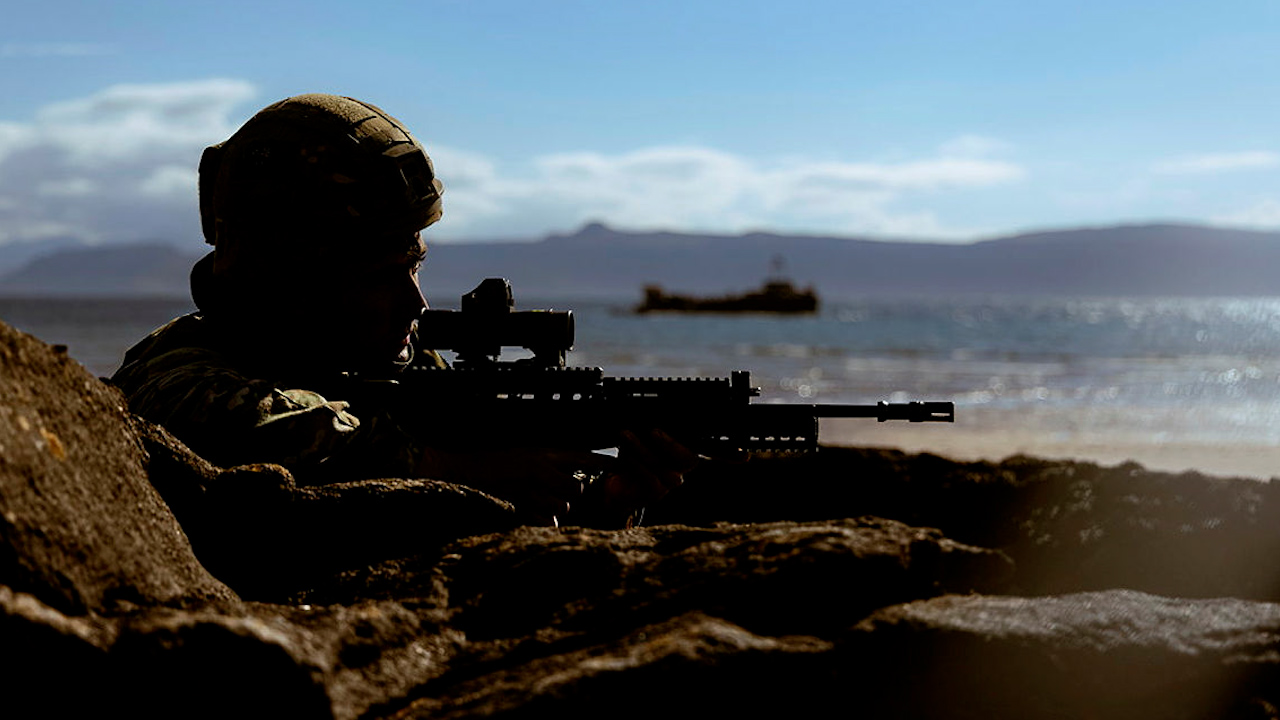 Royal Marines conduct wader drills during Operation Batan, Commandos survey the beach for potential threats after wading ashore from landing craft (Picture: MOD)