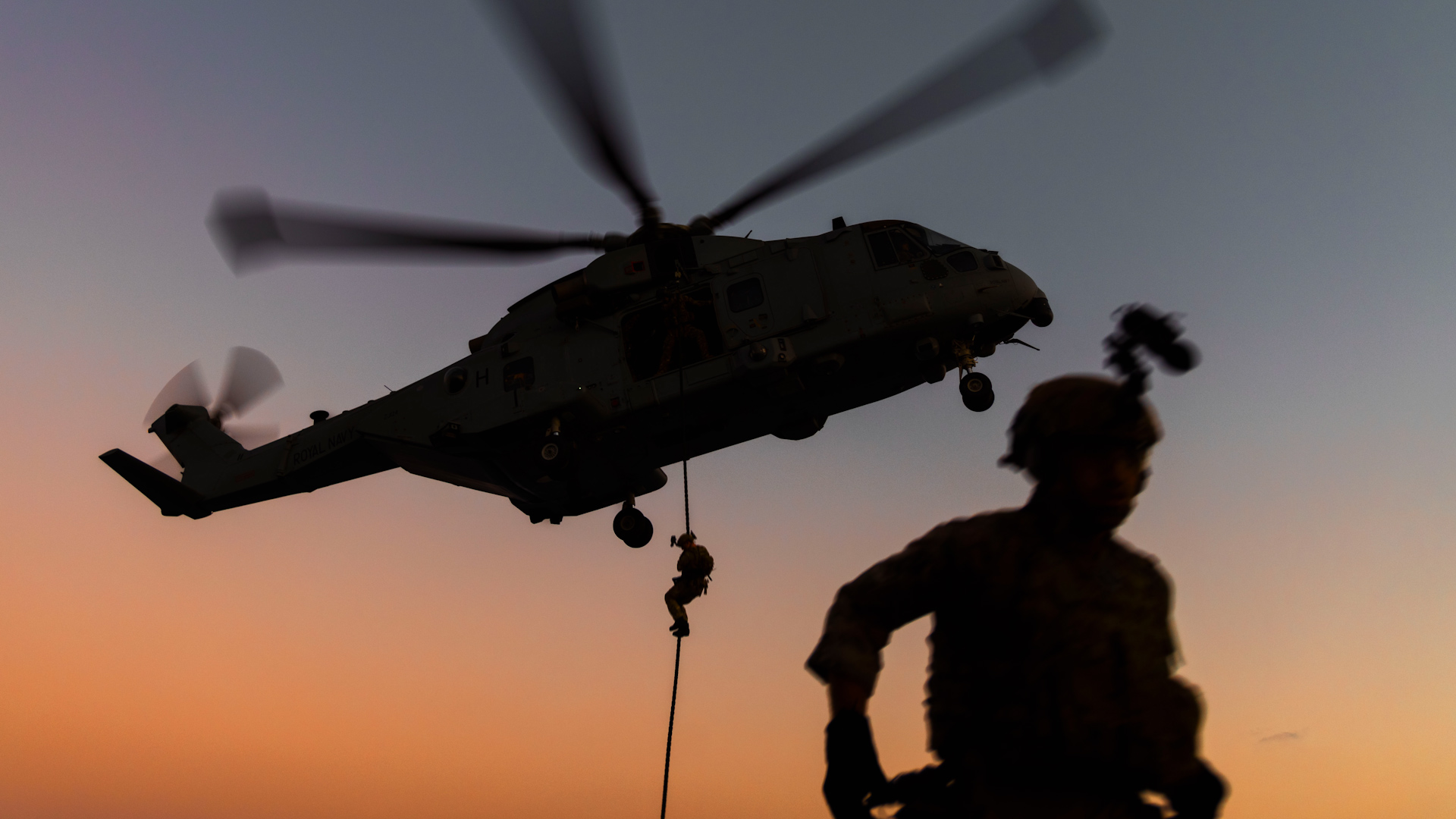 Royal Marines fast roping at sunset anon