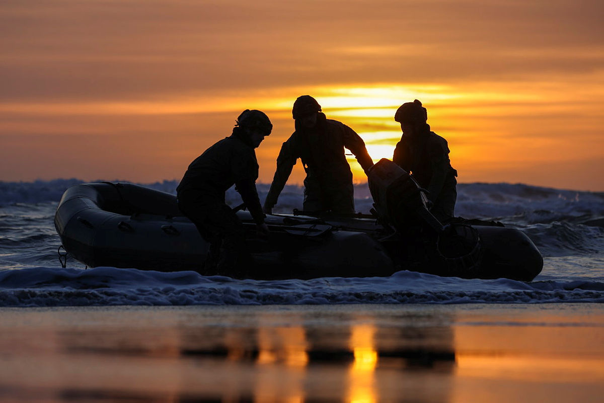 Royal Marines landing in the surf of Tregantle Beach at sunset