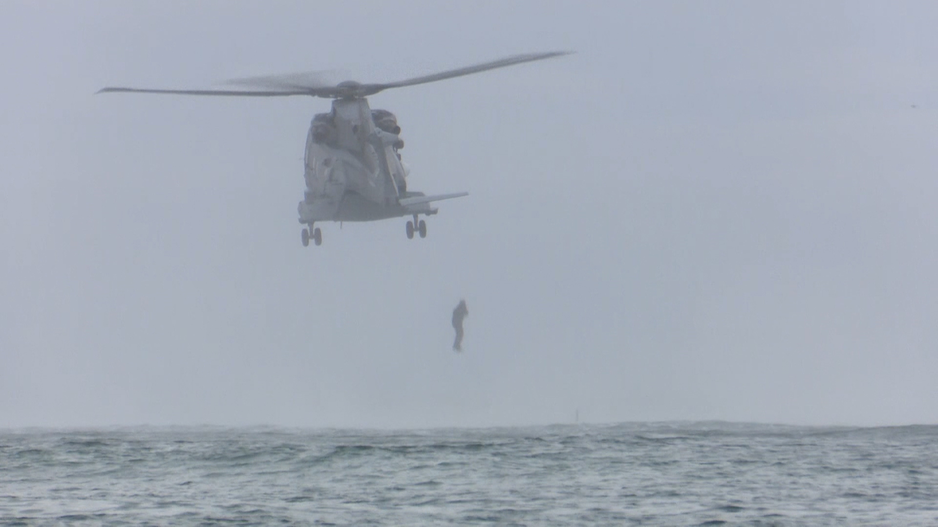 Marines jump from a Merlin helicopter.