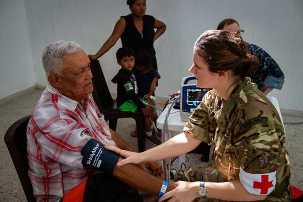 MA Smith recording a patient's blood pressure