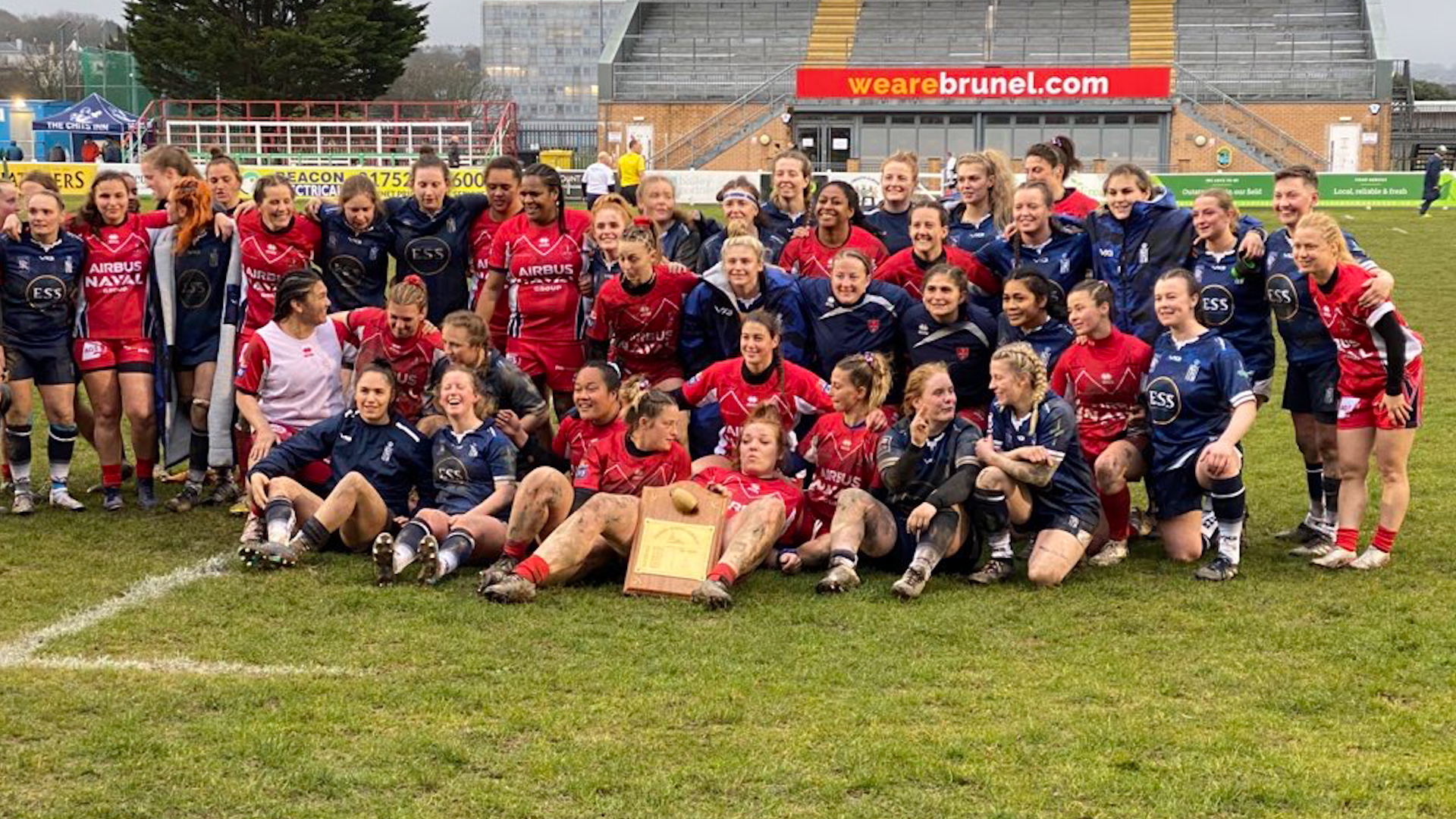 Royal Navy and Marine Nationale women's rugby teams posing for a group photo after playing each other in Plymouth