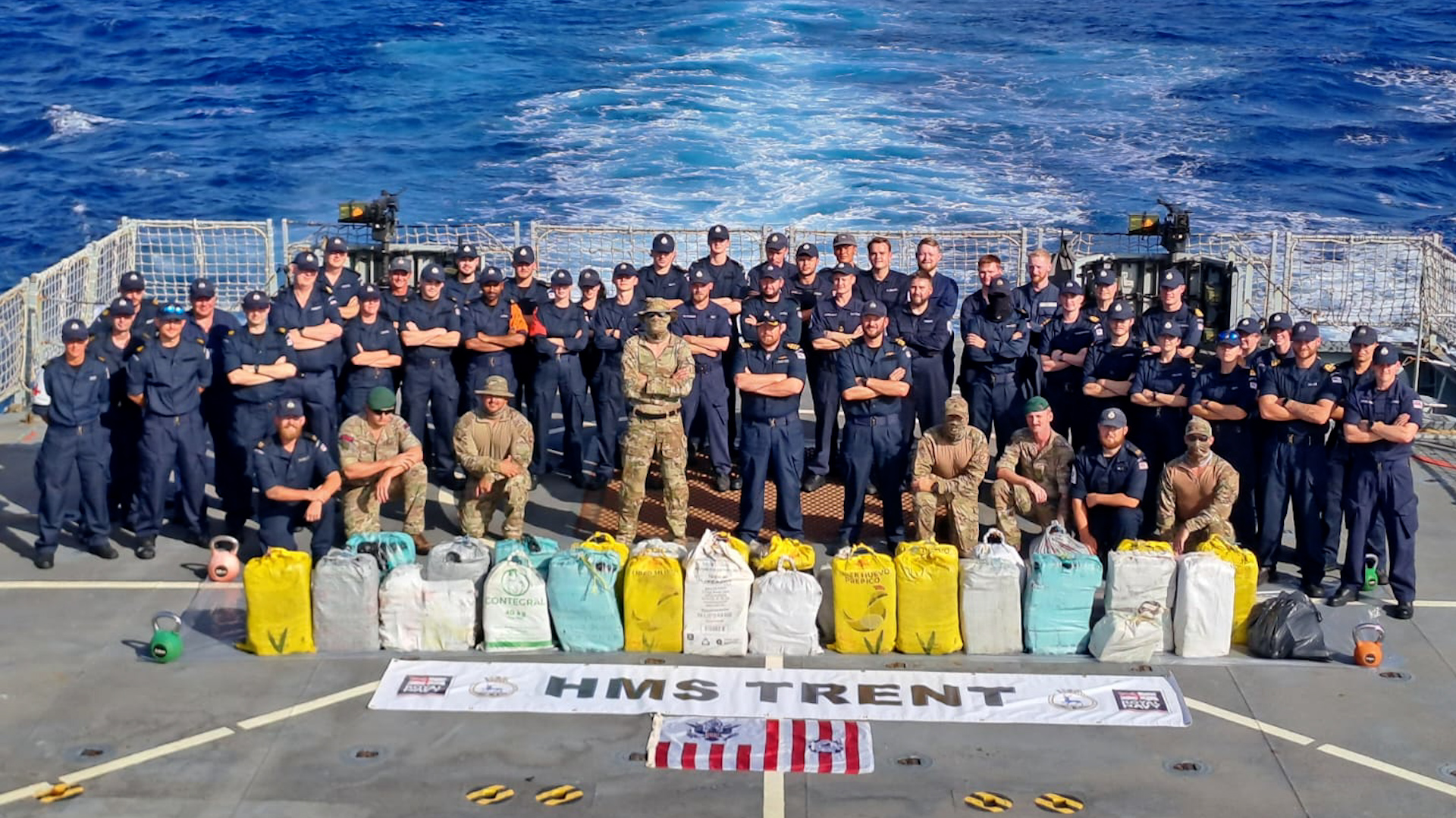 Royal Navy personnel on HMS Trent stand with seized drugs in the Caribbean Sea in January (Picture: Royal Navy).