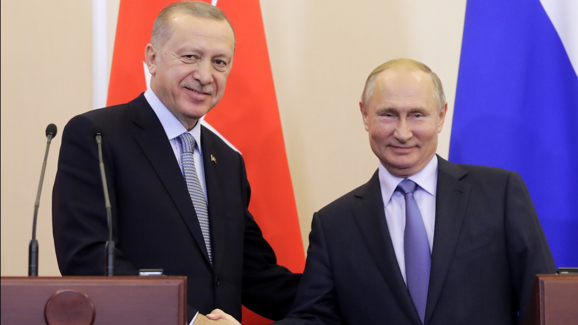 Turkish President Recep Tayyip Erdogan (left) and Russian President Vladimir Putin shake hands on Syrian deal (Picture: PA images).