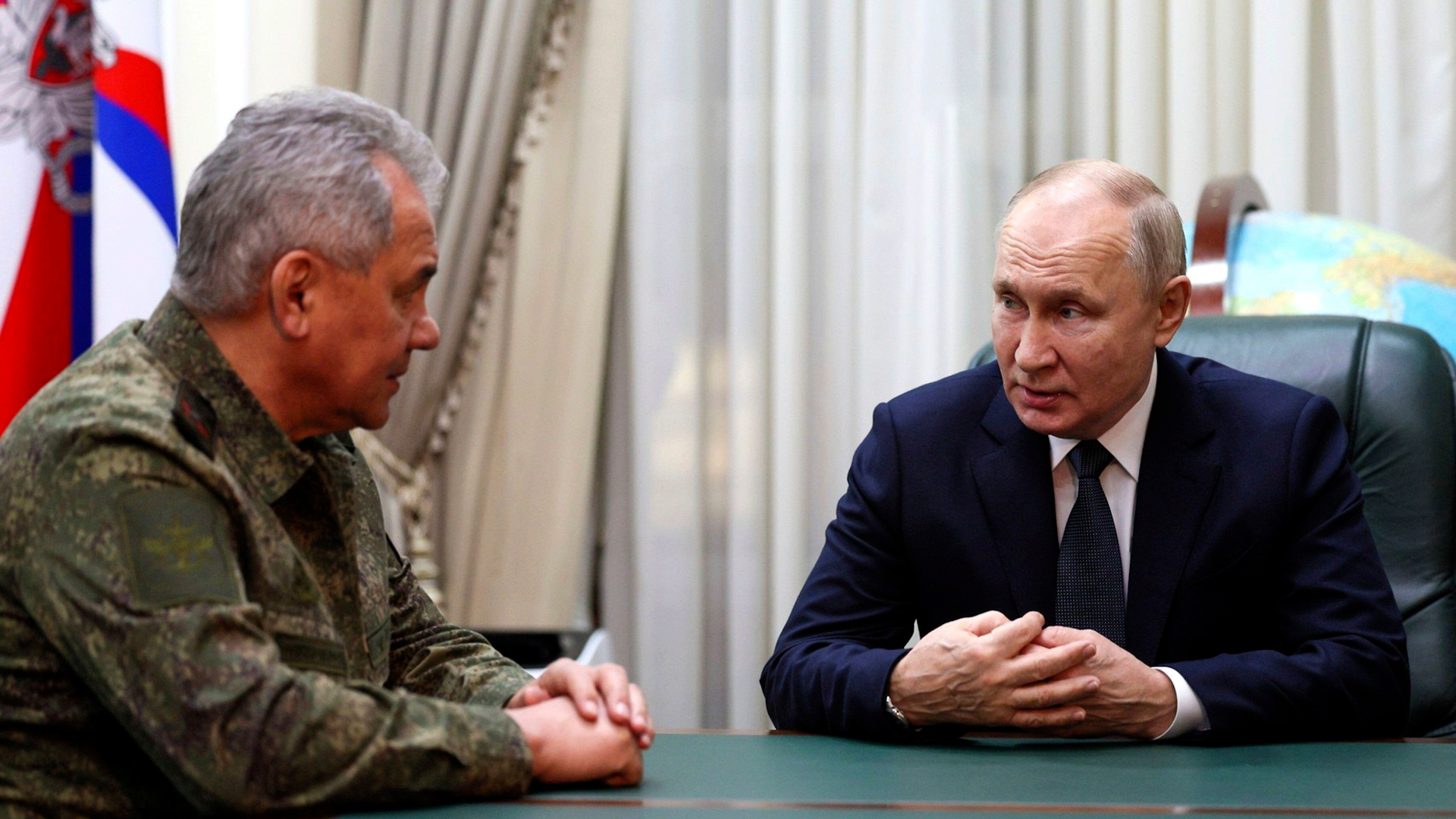 Russian President Vladimir Putin, right, is briefed by Defense Minister Sergei Shoigu in Rostov-on-Don, Russia