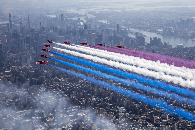 the Royal Air Force Aerobatic Team, The Red Arrows flying over New York streaming the Red, White and Blue.