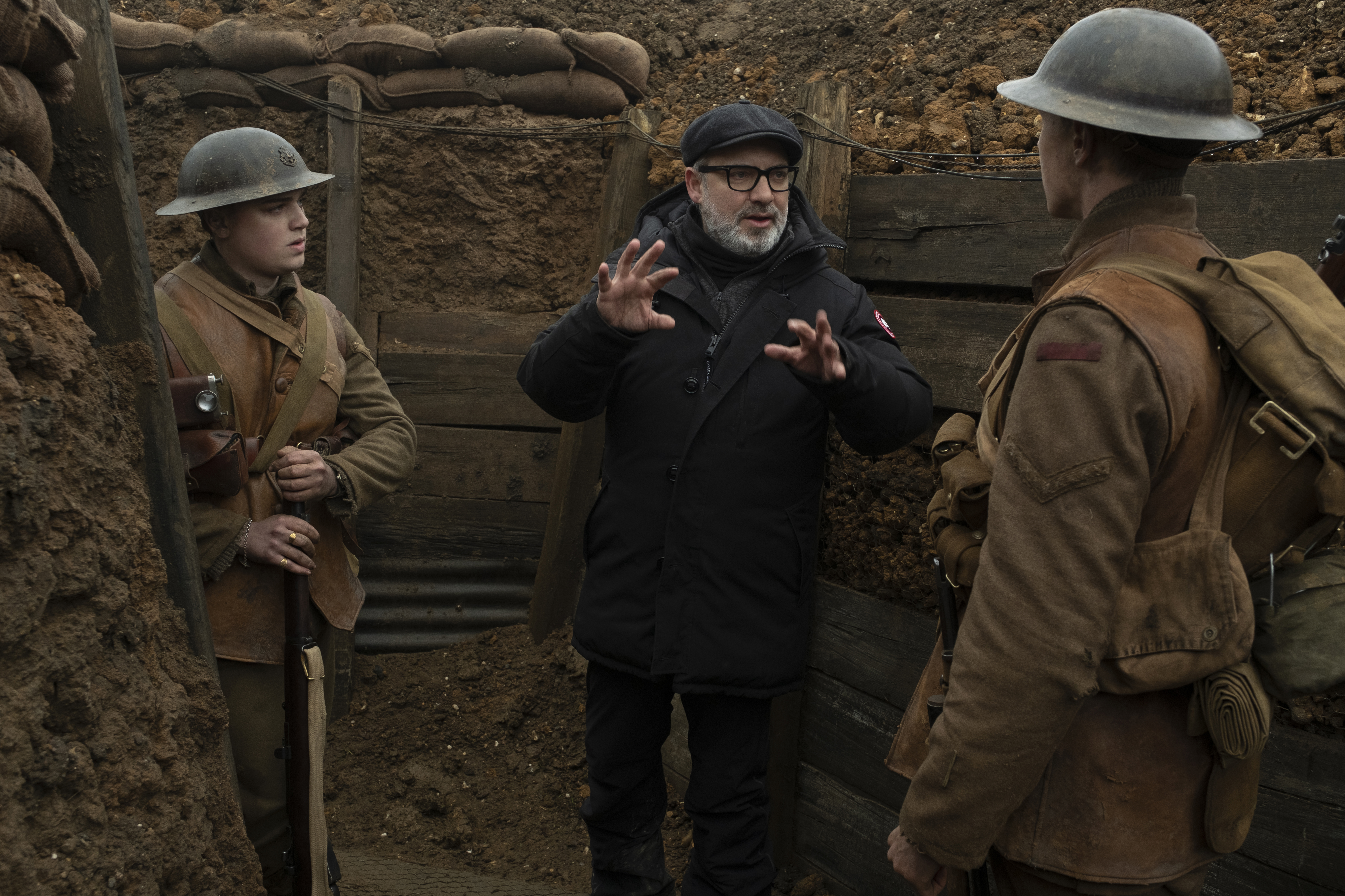 Sam Mendes on set with lead actors, George McKay and Dean-Charles Chapman