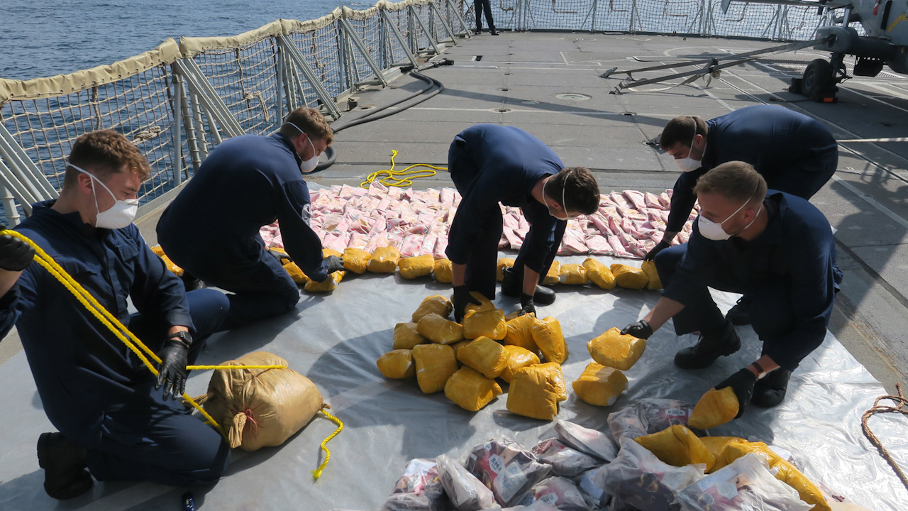 Sailors onboard HMS Lancaster sorting through the haul of heroin and hash (Picture: Royal Navy).