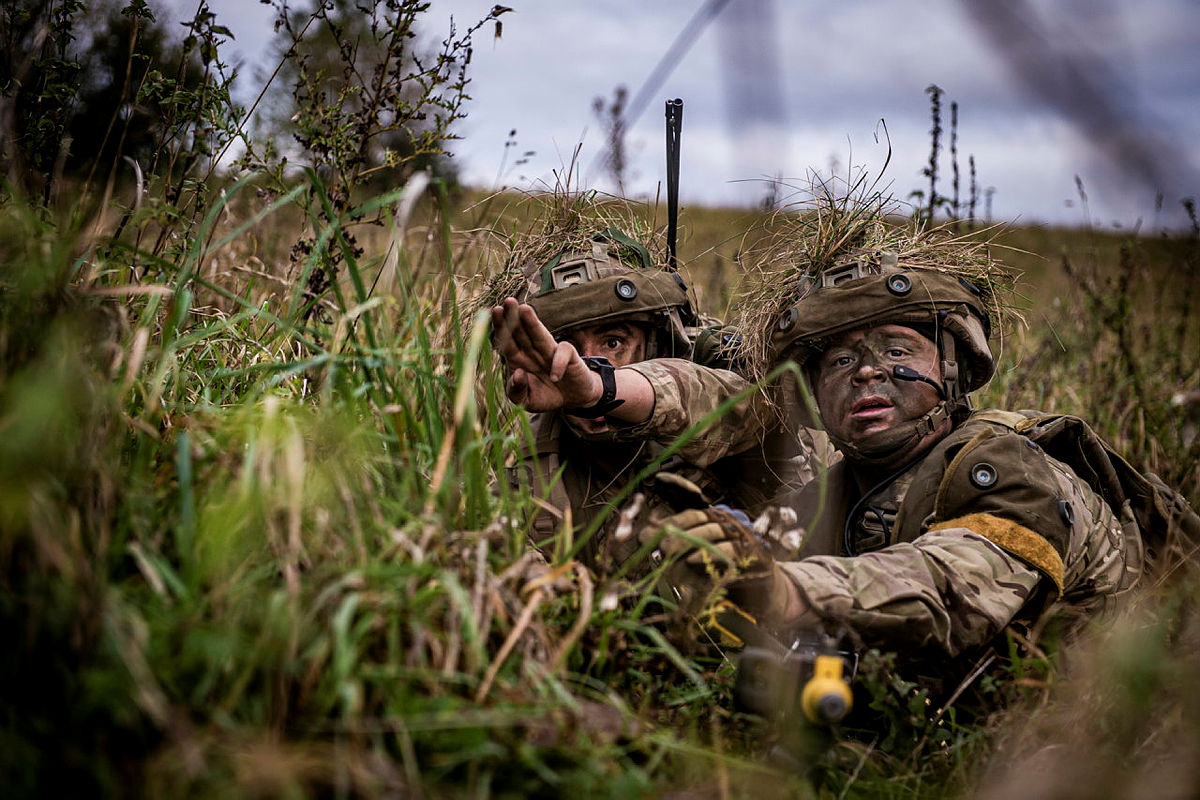 Two British soldiers hiding in long grass