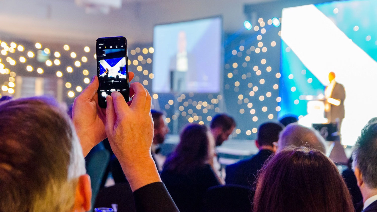 An audience member takes a photo at the Scottish Ex-Forces in Business Awards CREDIT Ex-Forces in Business Awards