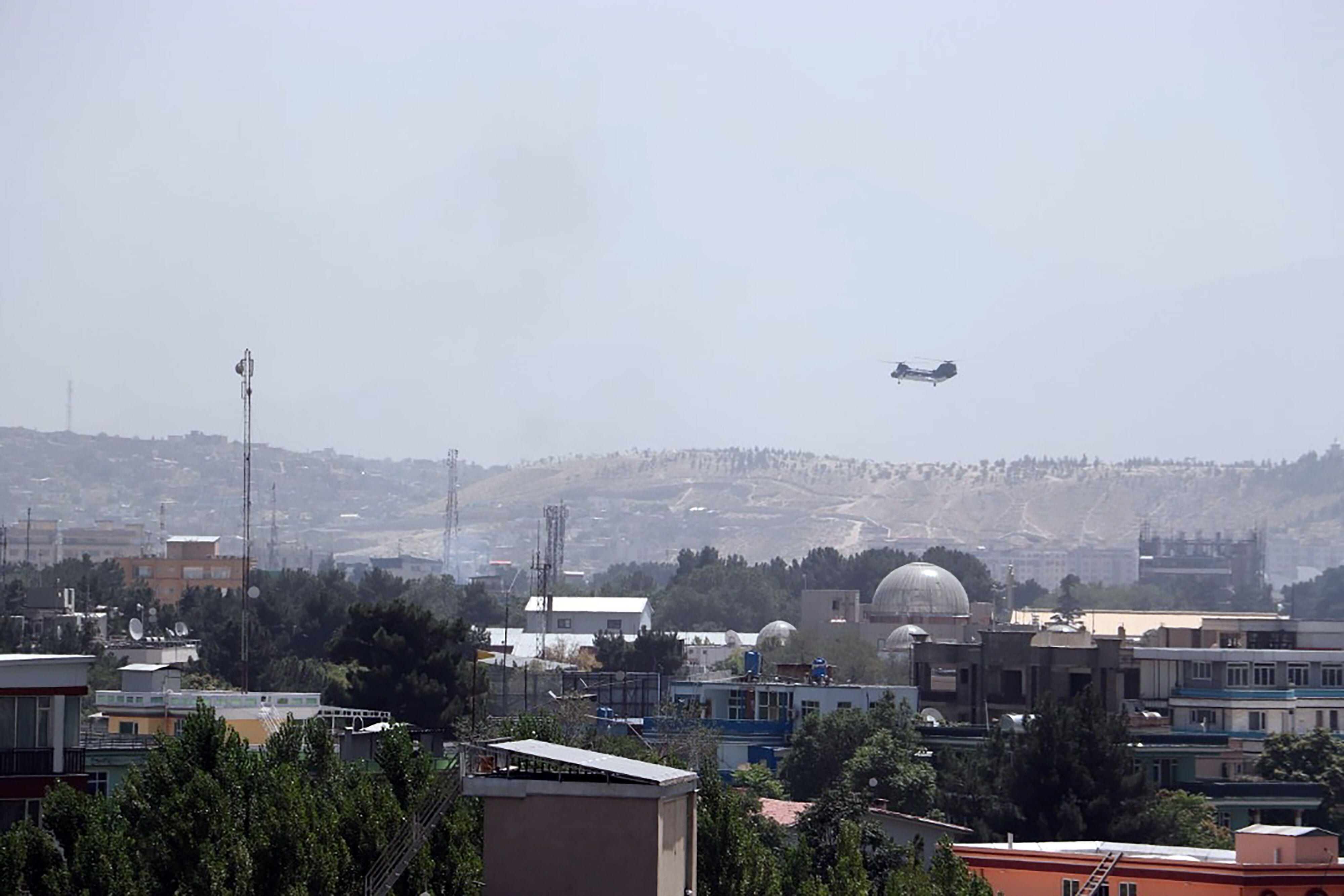 A Sea Knight military transport helicopter flies over Kabul as Taliban enters Kabul and West evacuates (Picture: UPI, Alamy).