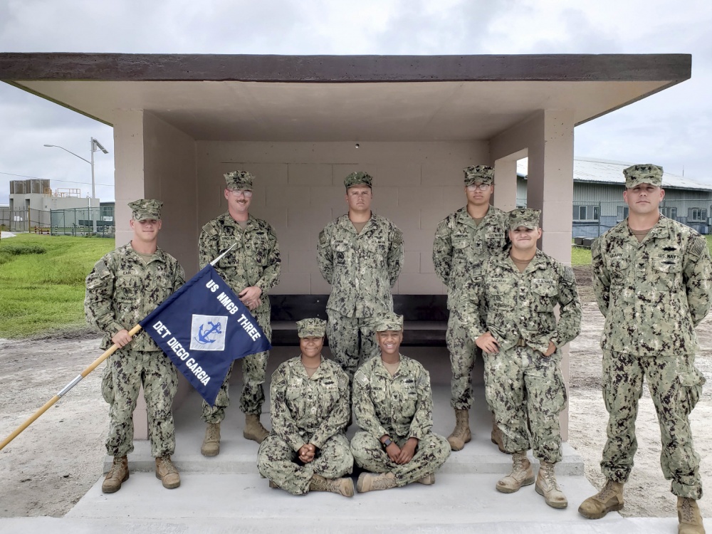 Seabees in Diego Garcia, pose for a group photo in front of a bus stop they constructed 131218 CREDIT US NAVY.jpg