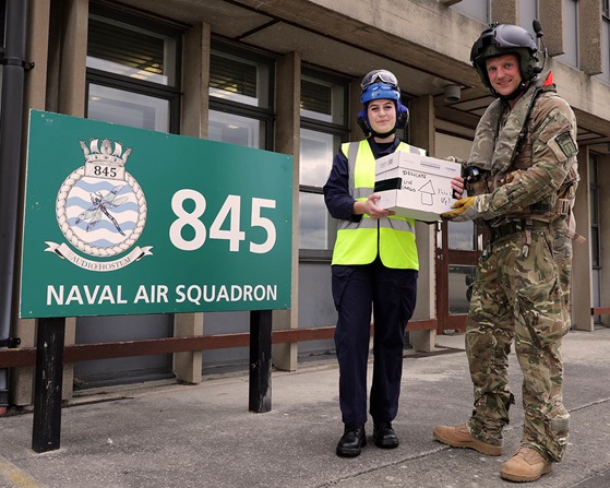 Sergeant Howling handing over the chicks saved from HMS Queen Elizabeth to AB Jones at 845 NAS, RNAS Yeovilton (Picture: Royal Navy).