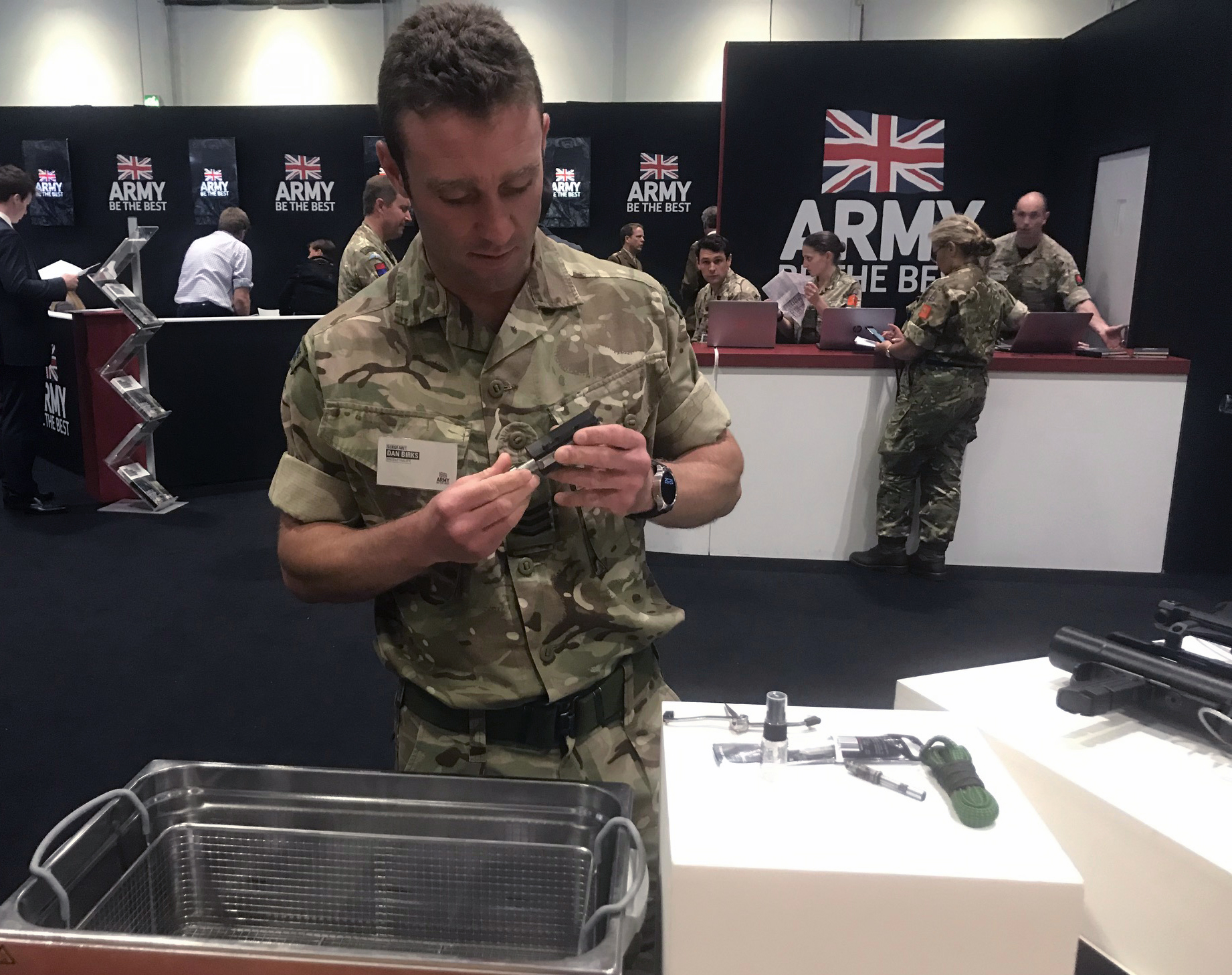 Sgt Dan Birks displays the Ultrasonic Cleaning Bath at DSEI fair. Credit: Georgina Coupe, BFBS