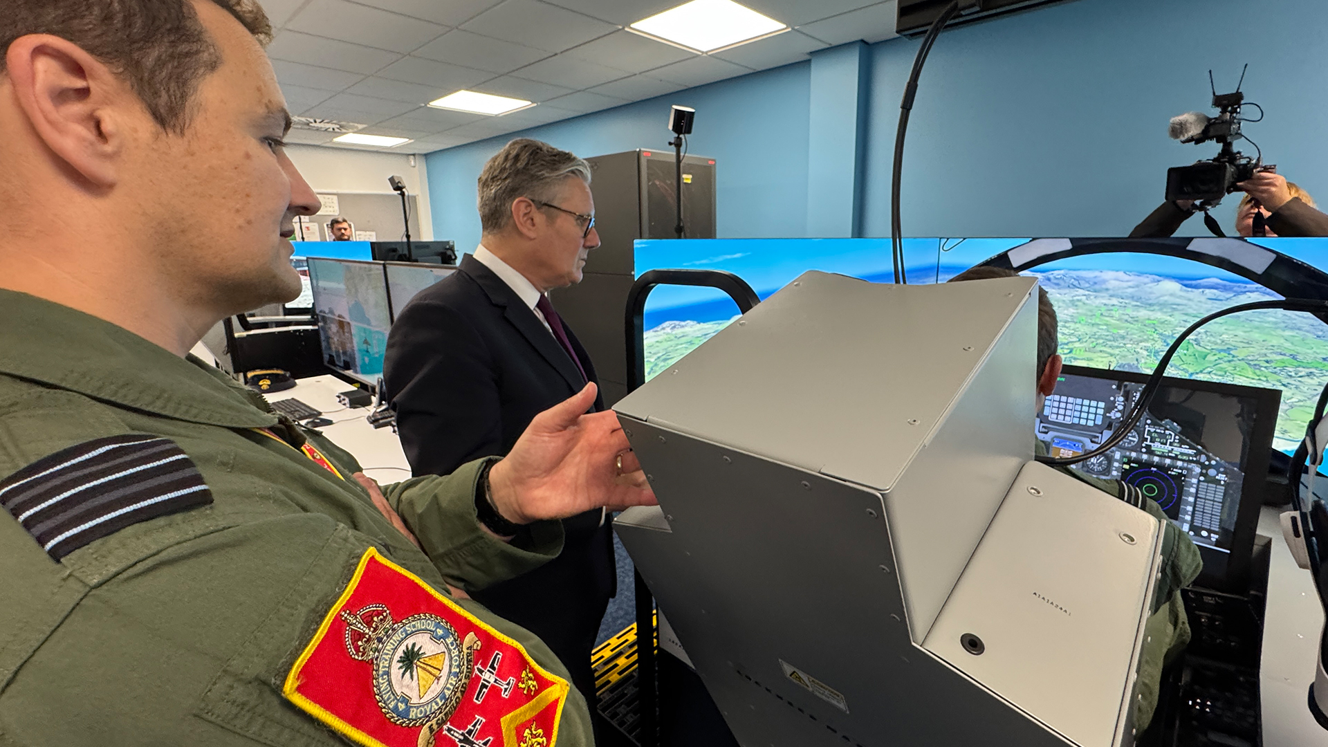 Sir Keir, seen here watching a trainee fly a Hawk simulator, discussed the RAF's fast jet training requirements with the team at RAF Valley