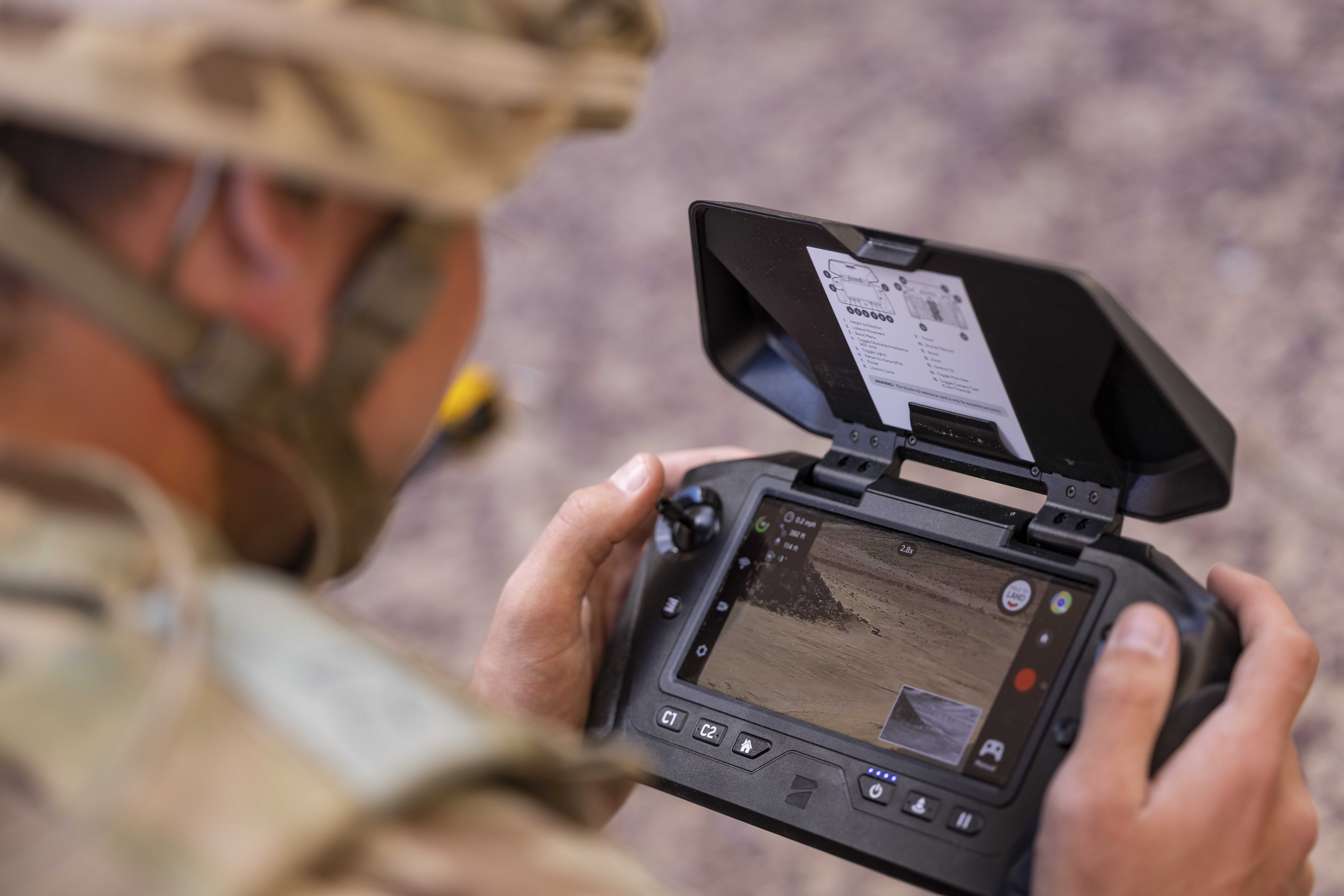 Soldier operating a drone on a console