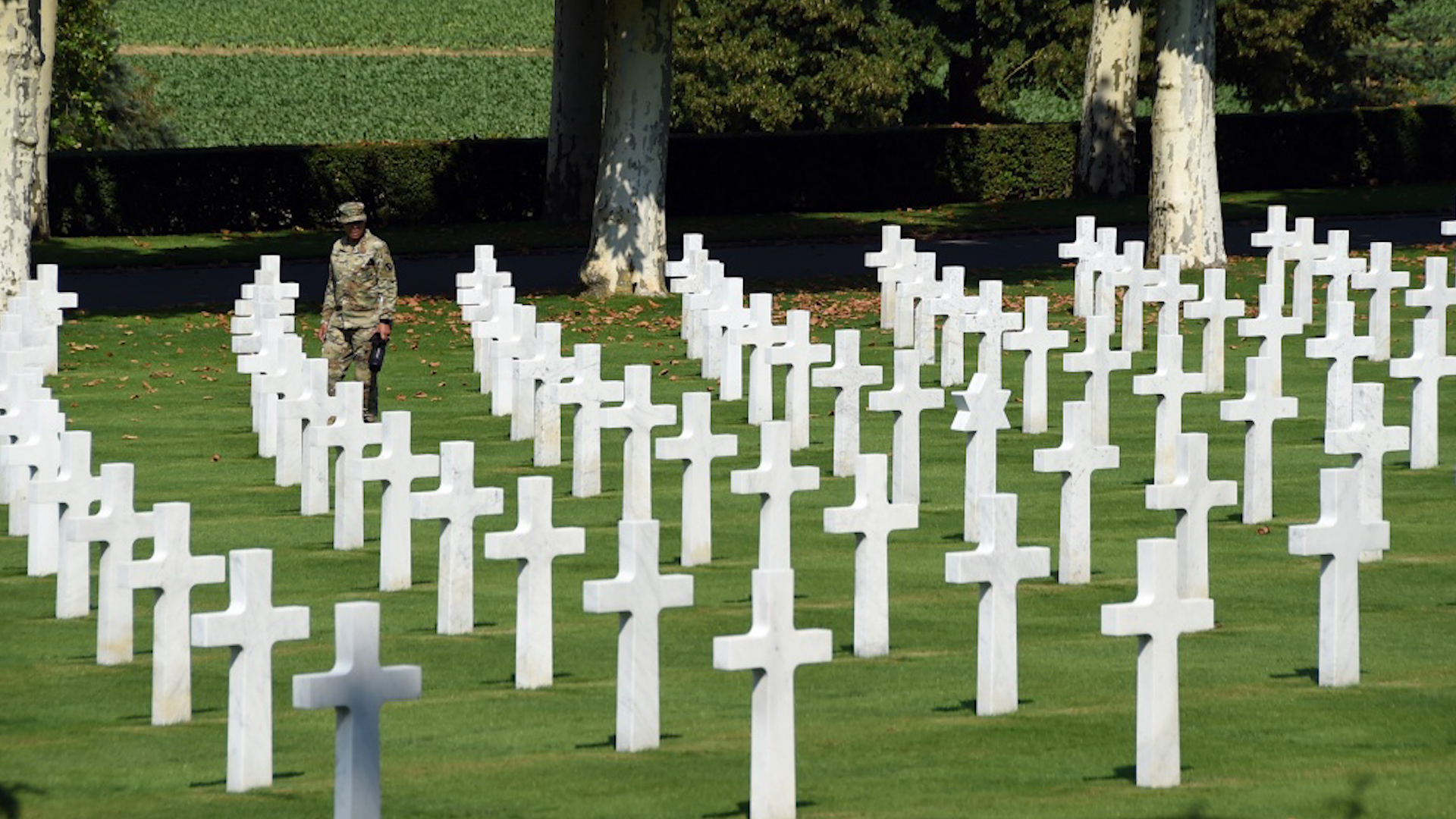 Soldier walks among graves at Aisne-Marne American Cemetery and Memorial 260718.jpg 