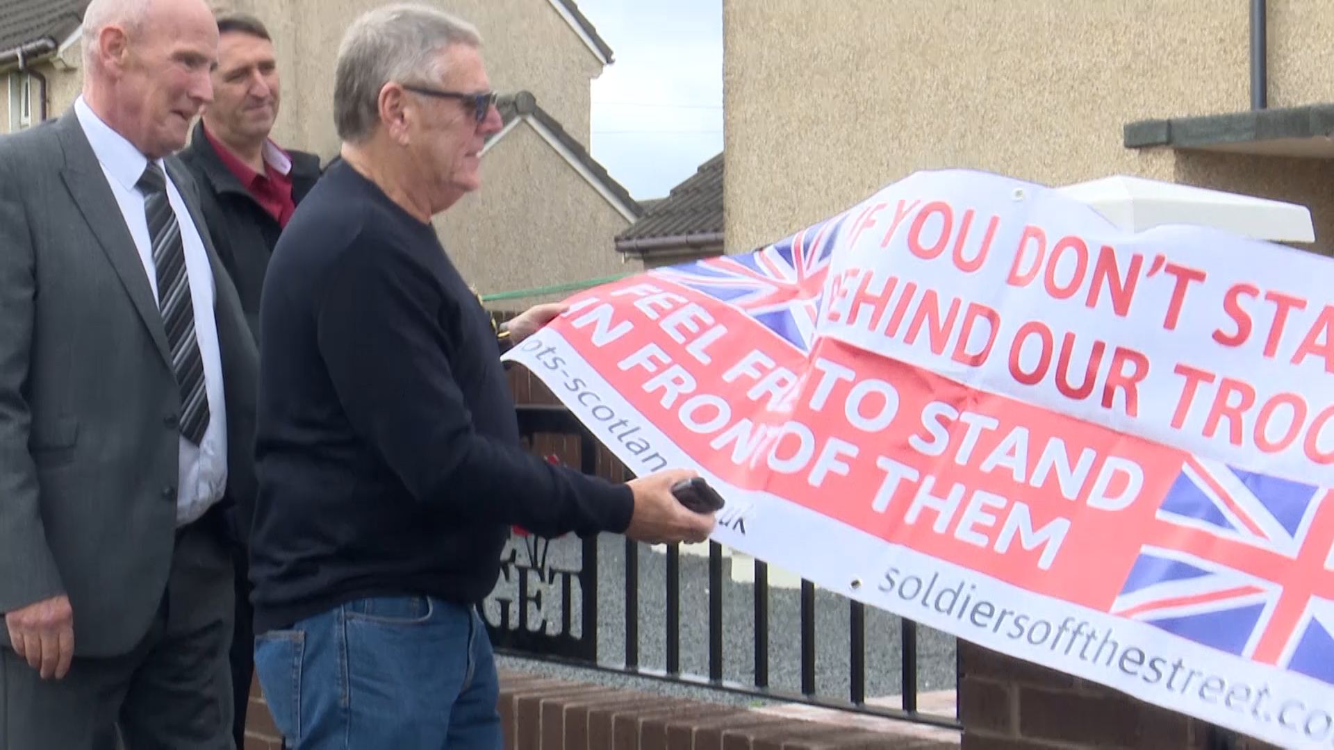 Craig Barber's father unveils the plaque that bears his name.