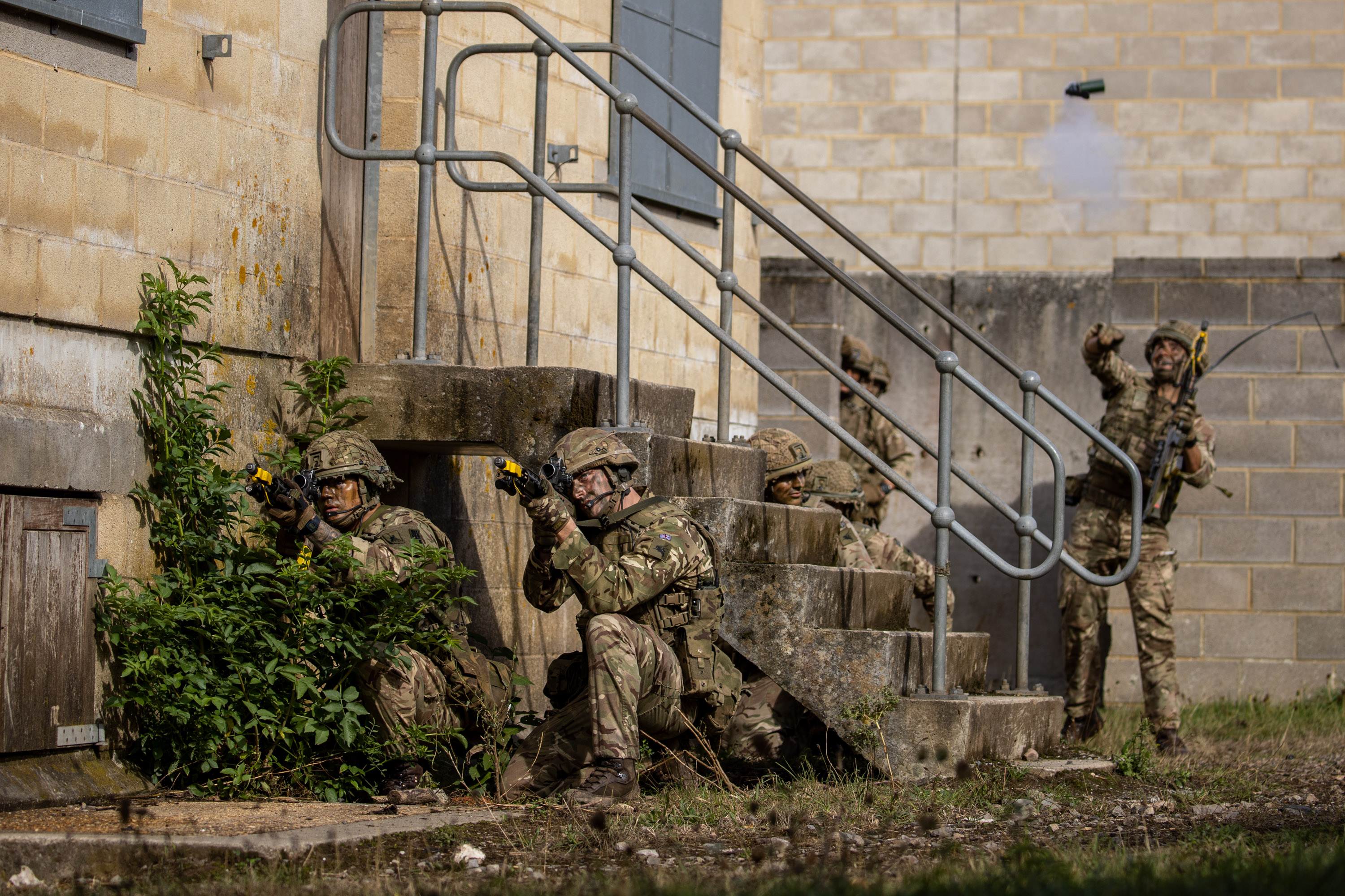 Soldiers behind a building