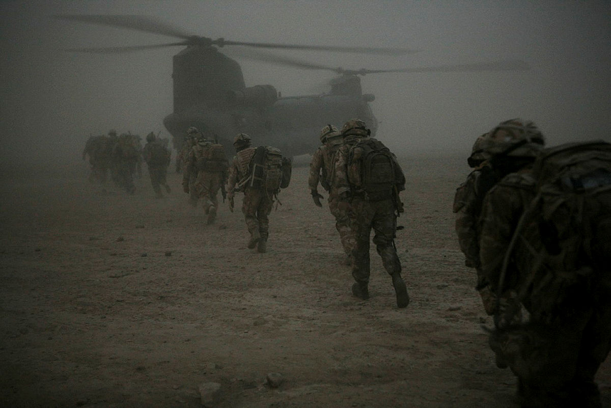 Soldiers board a chinook helicopter in the desert in Afghanistan in 2009 WO1 Rupert Frere Picture Crown Copyright)