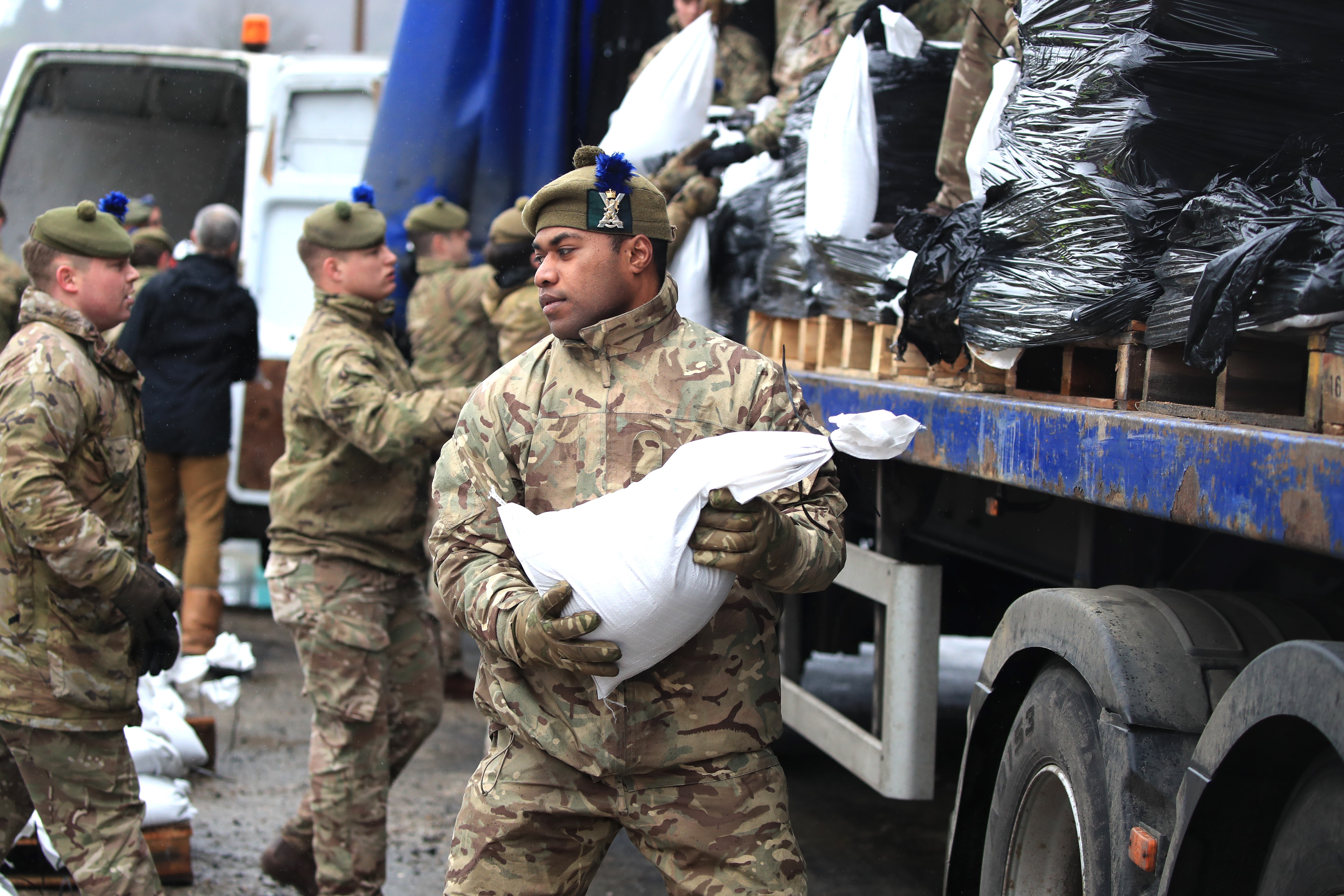Soldiers from 4 Scots help with the flood relief effort in Yorkshire over the weekend (Picture: PA).