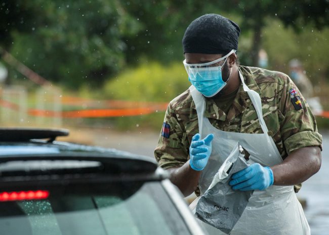 A soldier from the London Regiment helps run a mobile testing unit in London in June last year (Picture: MOD).