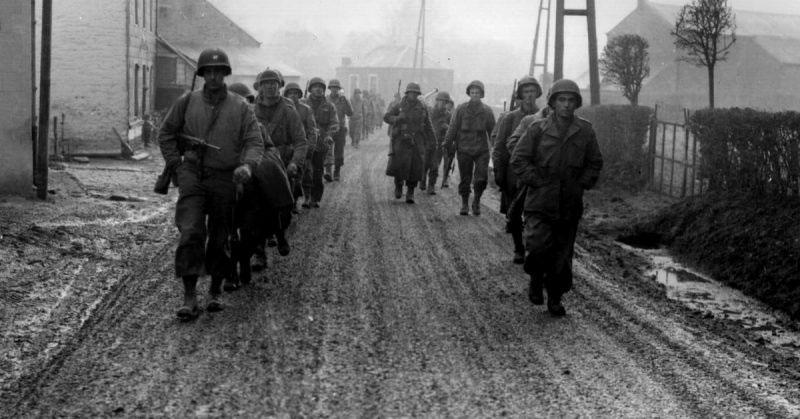 Soldiers of the 28th Infantry Division march down a street in Bastogne, Belgium, in December 1944 CREDIT US Army