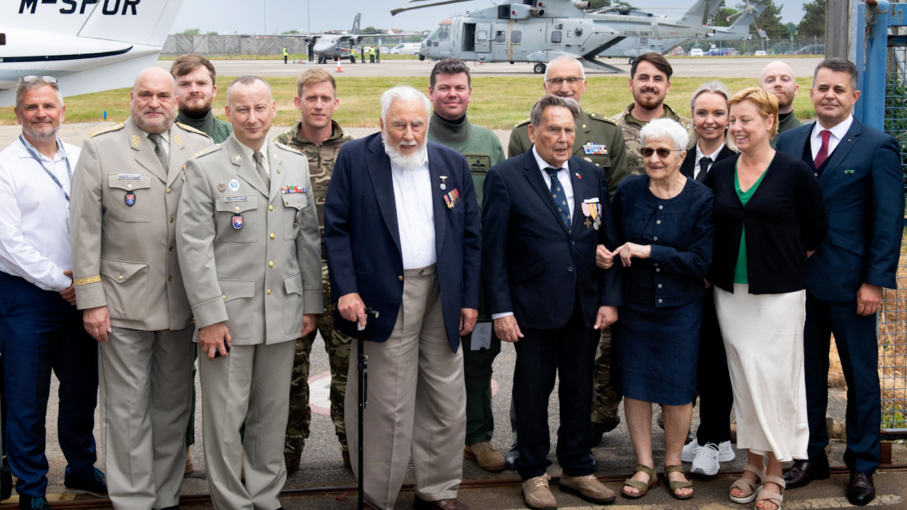 Members of the aircrew standing with Czech veterans Charles Strasser and Jirí Pavel Kafka in front of the 845 NAS Merlins in Jersey (Picture: Royal Navy)
