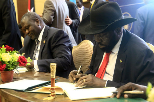 South Sudanese President Salva Kiir and major opposition leader Riek Machar sign on the final deal on power-sharing Picture PA