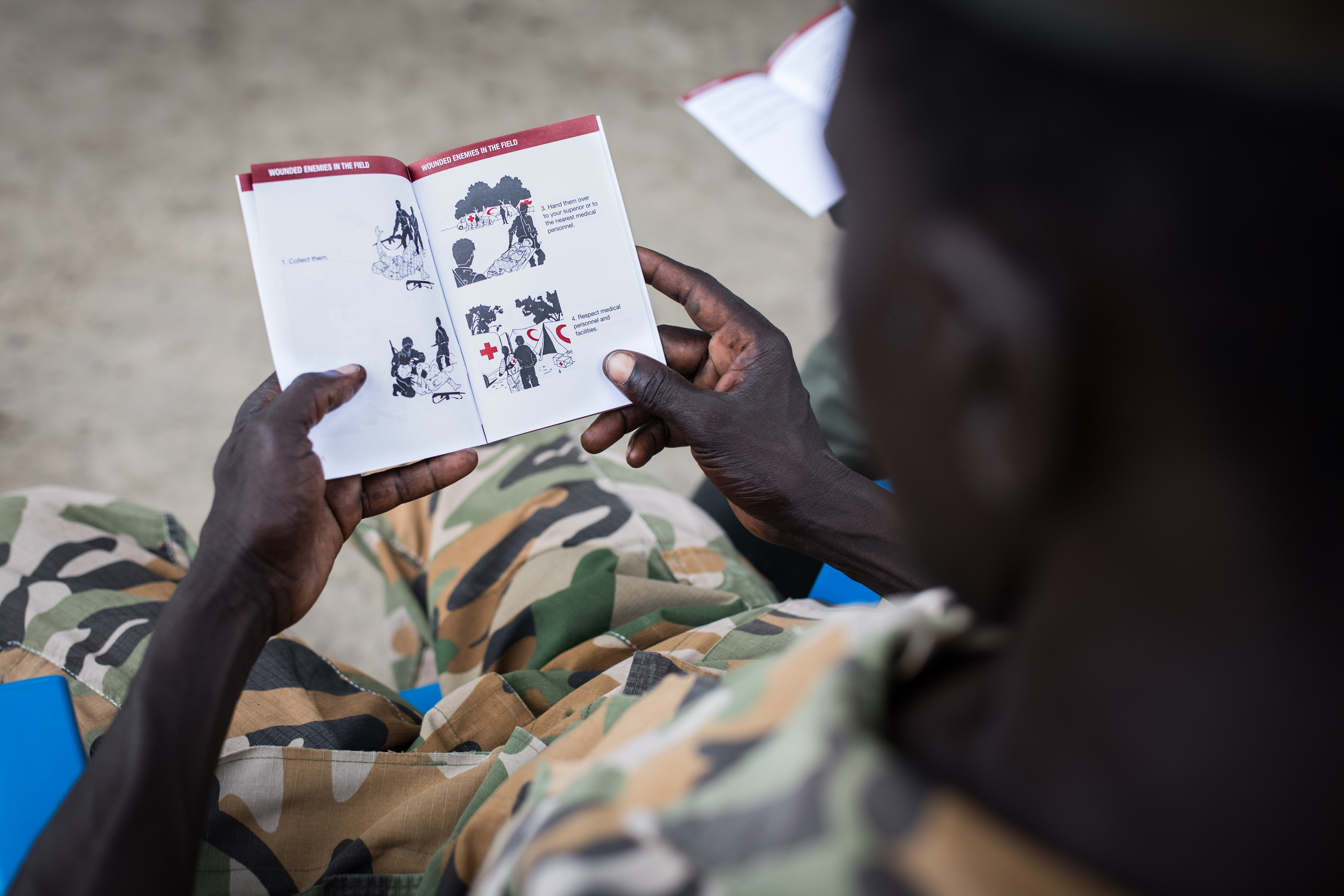 A South Sudanese soldier looks through a first aid text book (Picture: ICRC/FlorianSeriex).