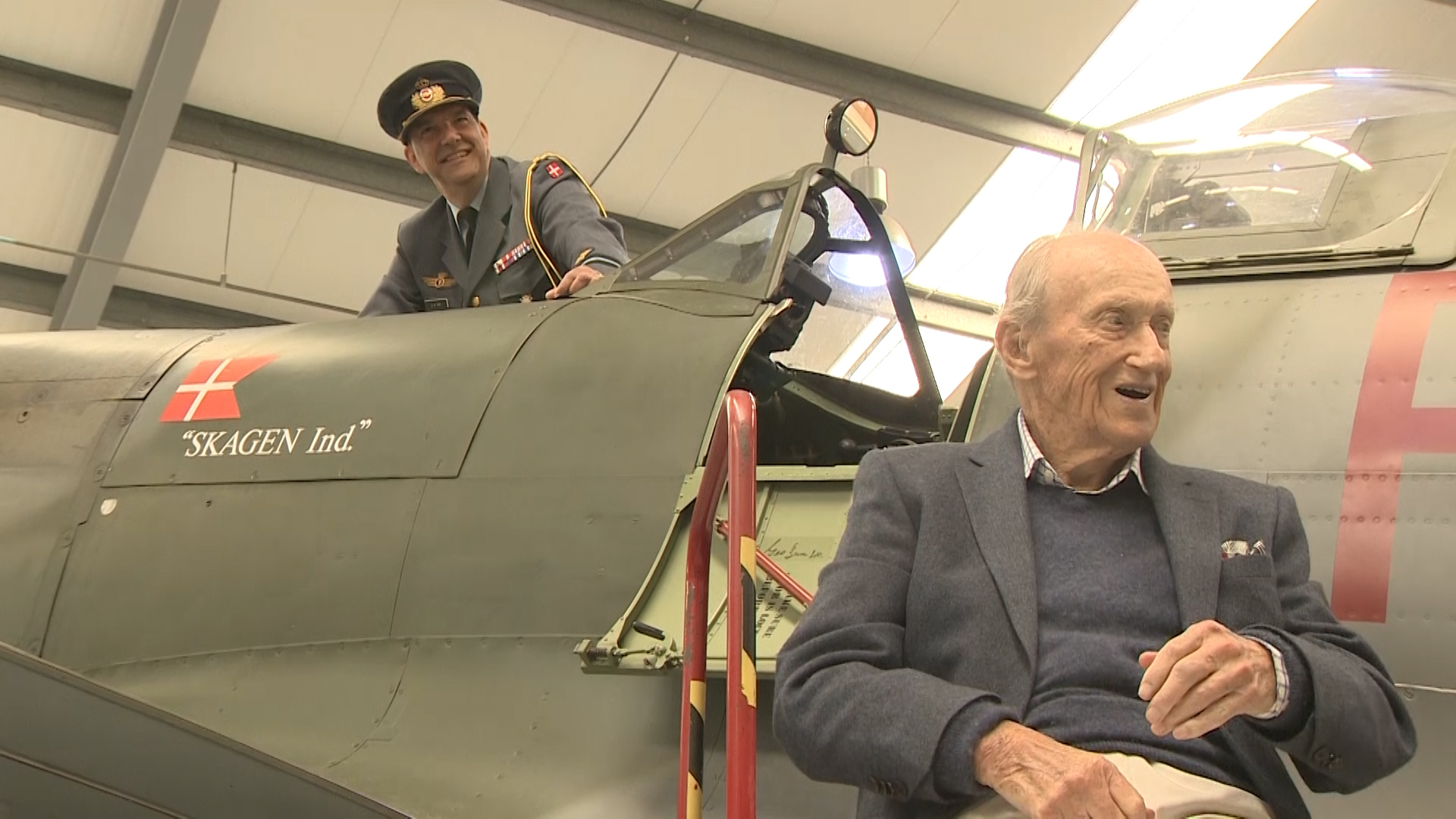 Danish Defence Attaché Brigadier-General Jan K Toft with Hans Eigel next to Spitfire adorned with the Danish flag.